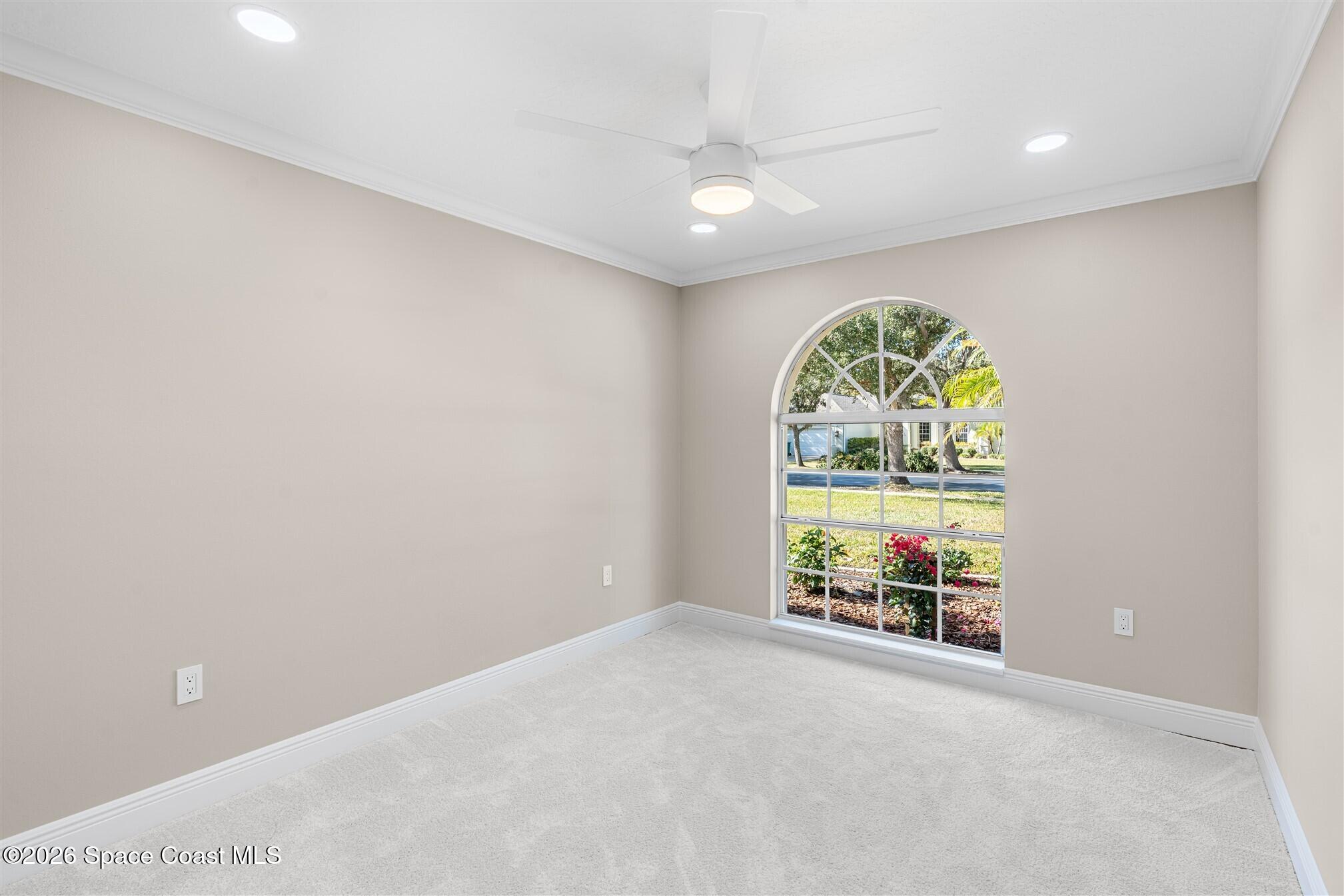 8033 Kingswood Way Melbourne, FL 32940 - Photo 42 of 70 an empty room with windows and painted walls