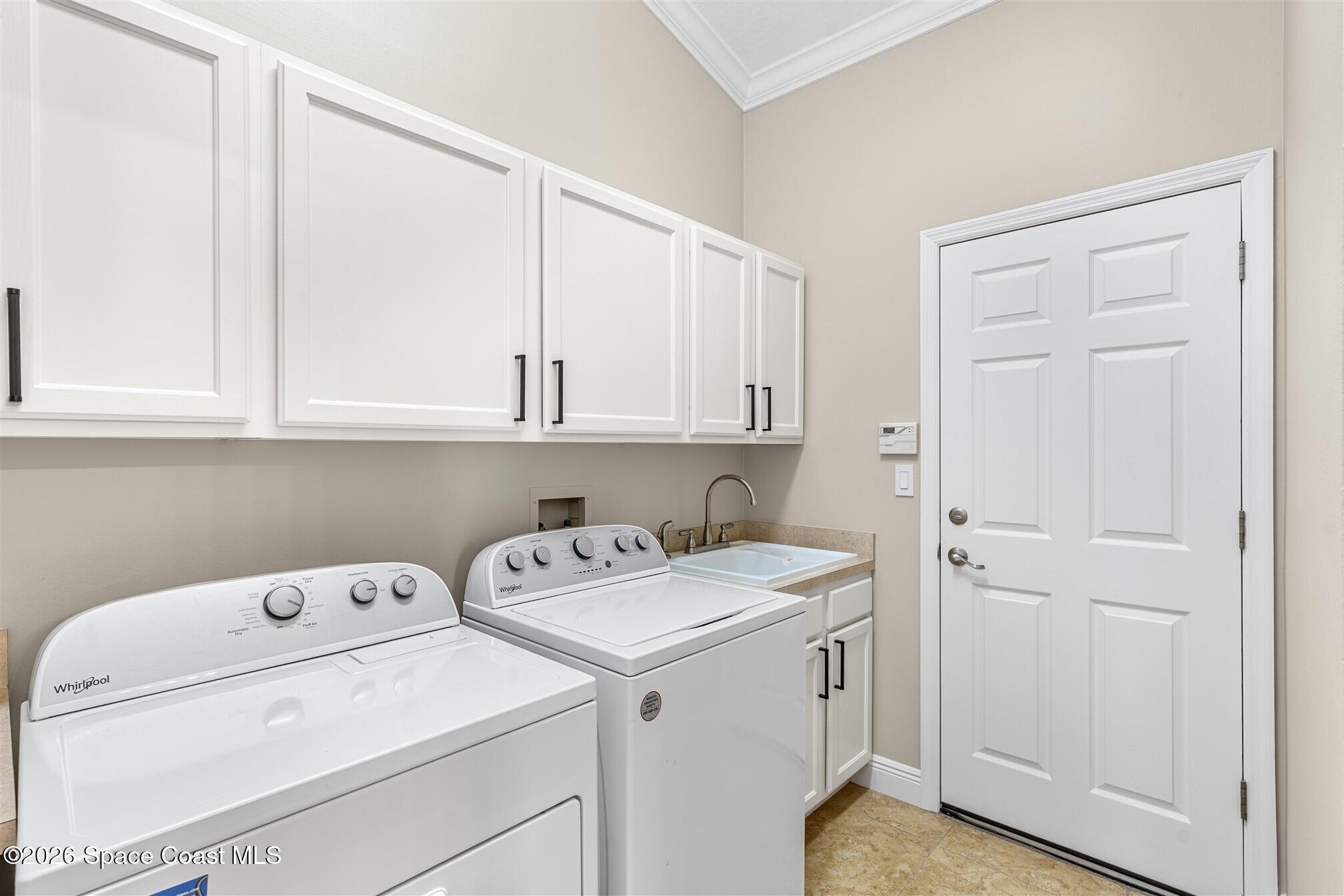 8033 Kingswood Way Melbourne, FL 32940 - Photo 46 of 70 a utility room with dryer and washer