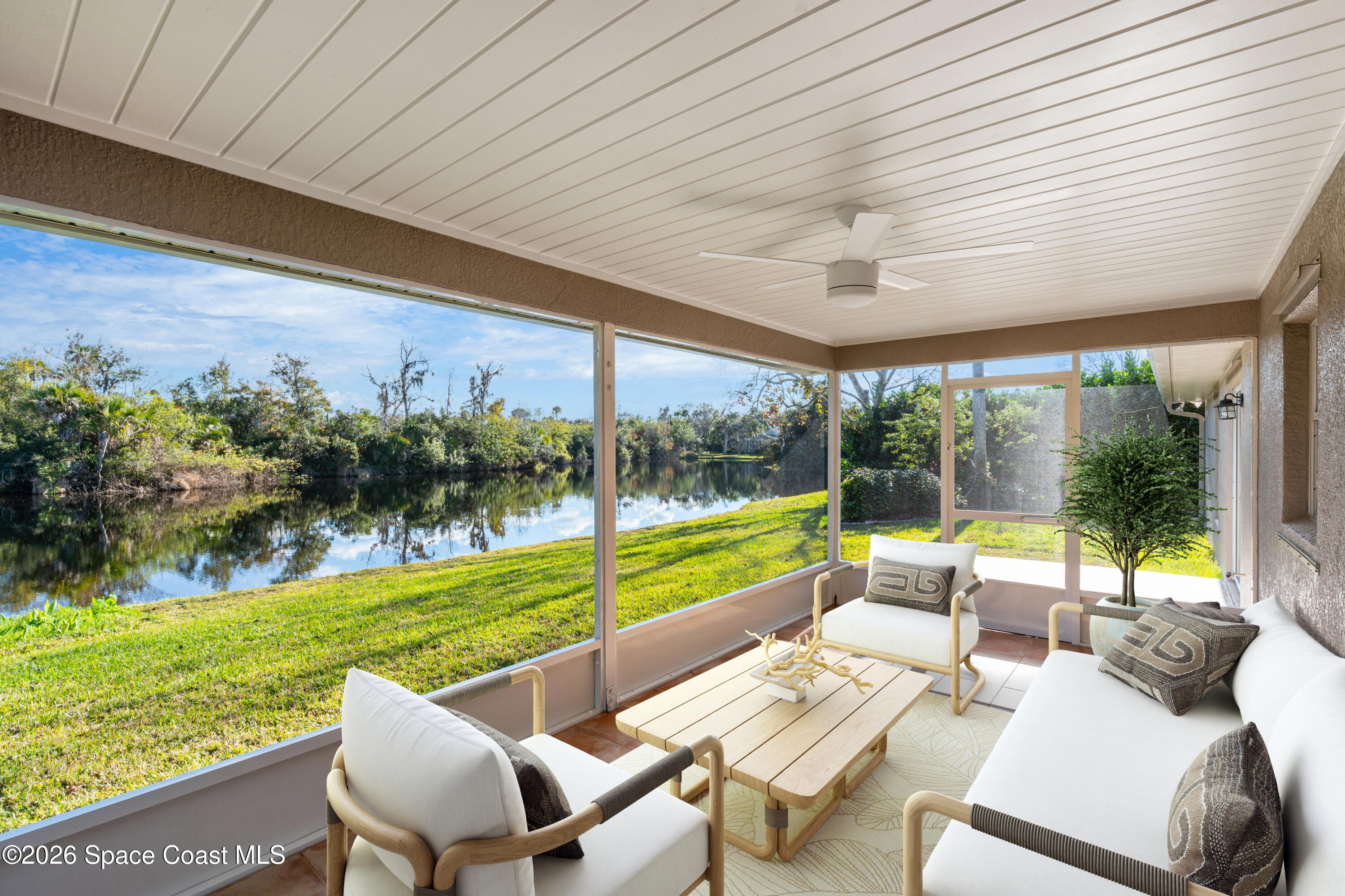 8033 Kingswood Way Melbourne, FL 32940 - Photo 47 of 70 a view of swimming pool with a table and chairs under an umbrella