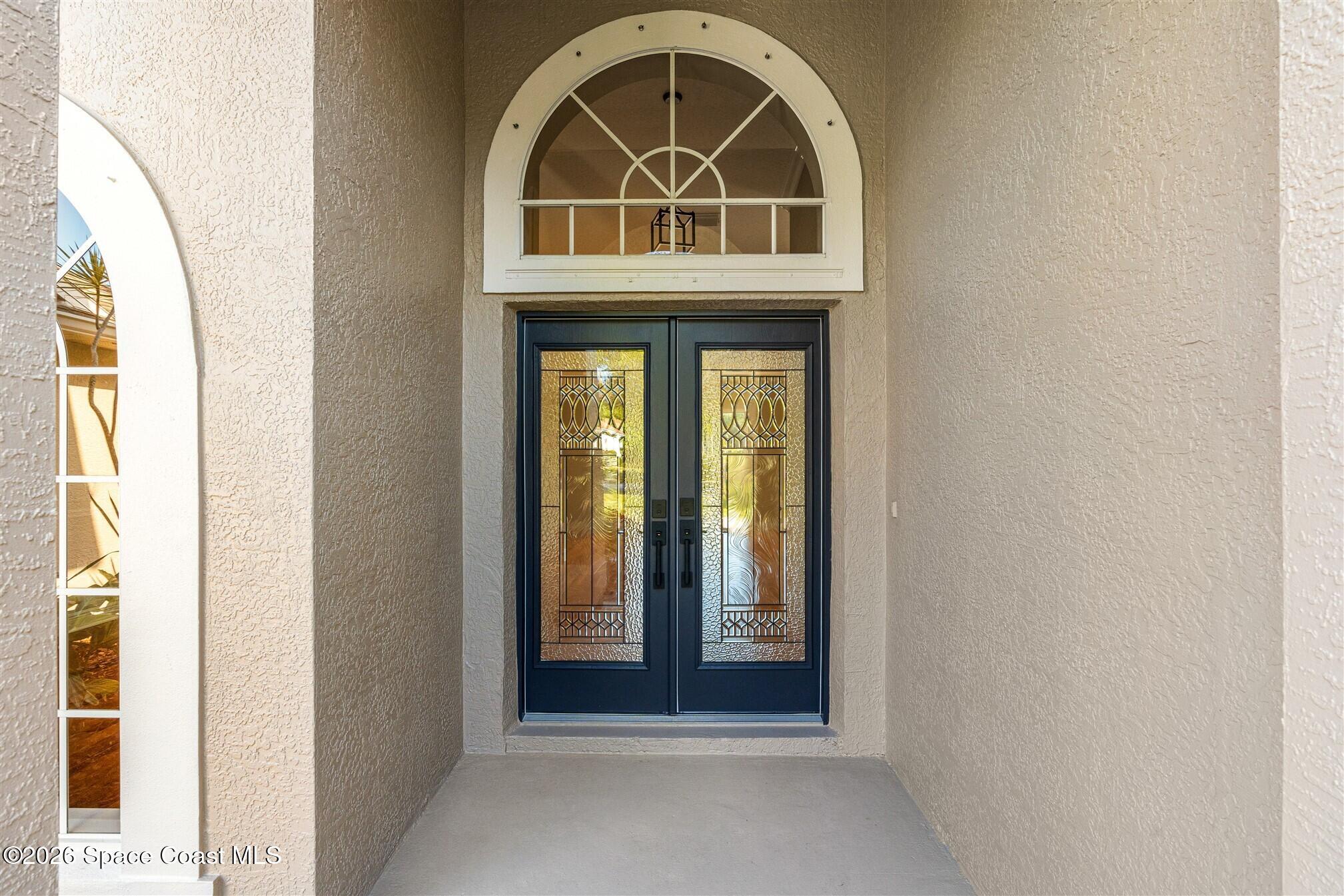 8033 Kingswood Way Melbourne, FL 32940 - Photo 5 of 70 a front view of a house with a white door