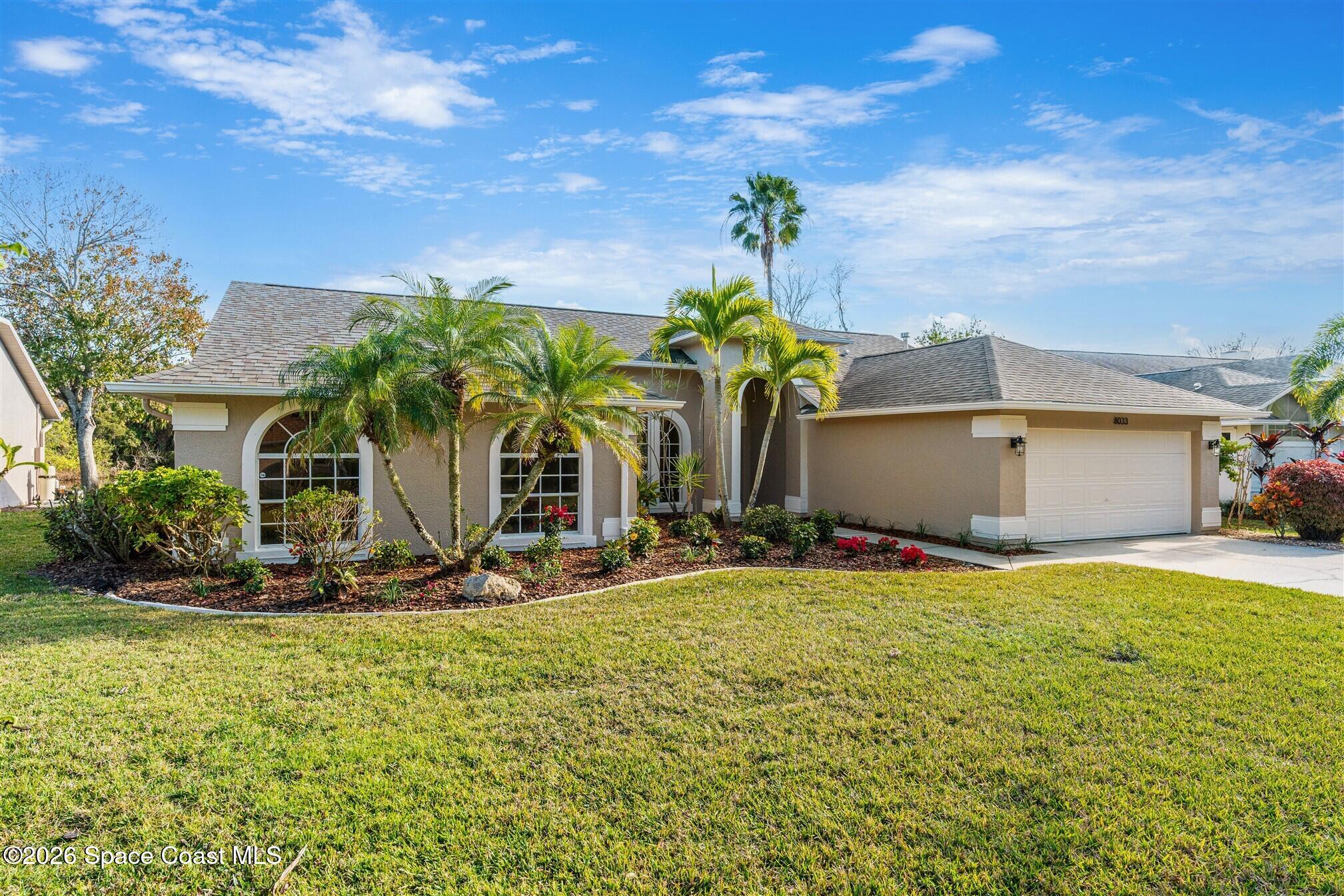8033 Kingswood Way Melbourne, FL 32940 - Photo 56 of 70 a front view of house with yard and seating