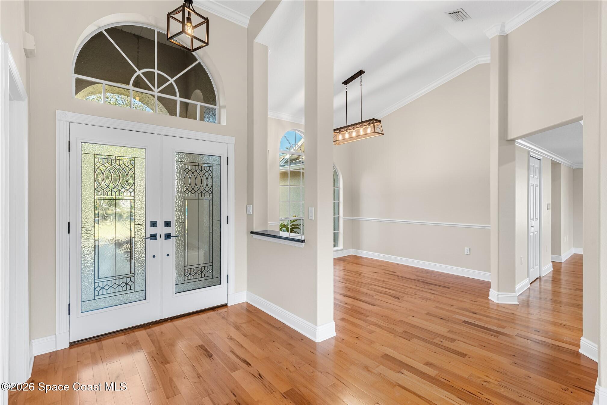 8033 Kingswood Way Melbourne, FL 32940 - Photo 7 of 70 a view of a hallway with wooden floor and a bathroom