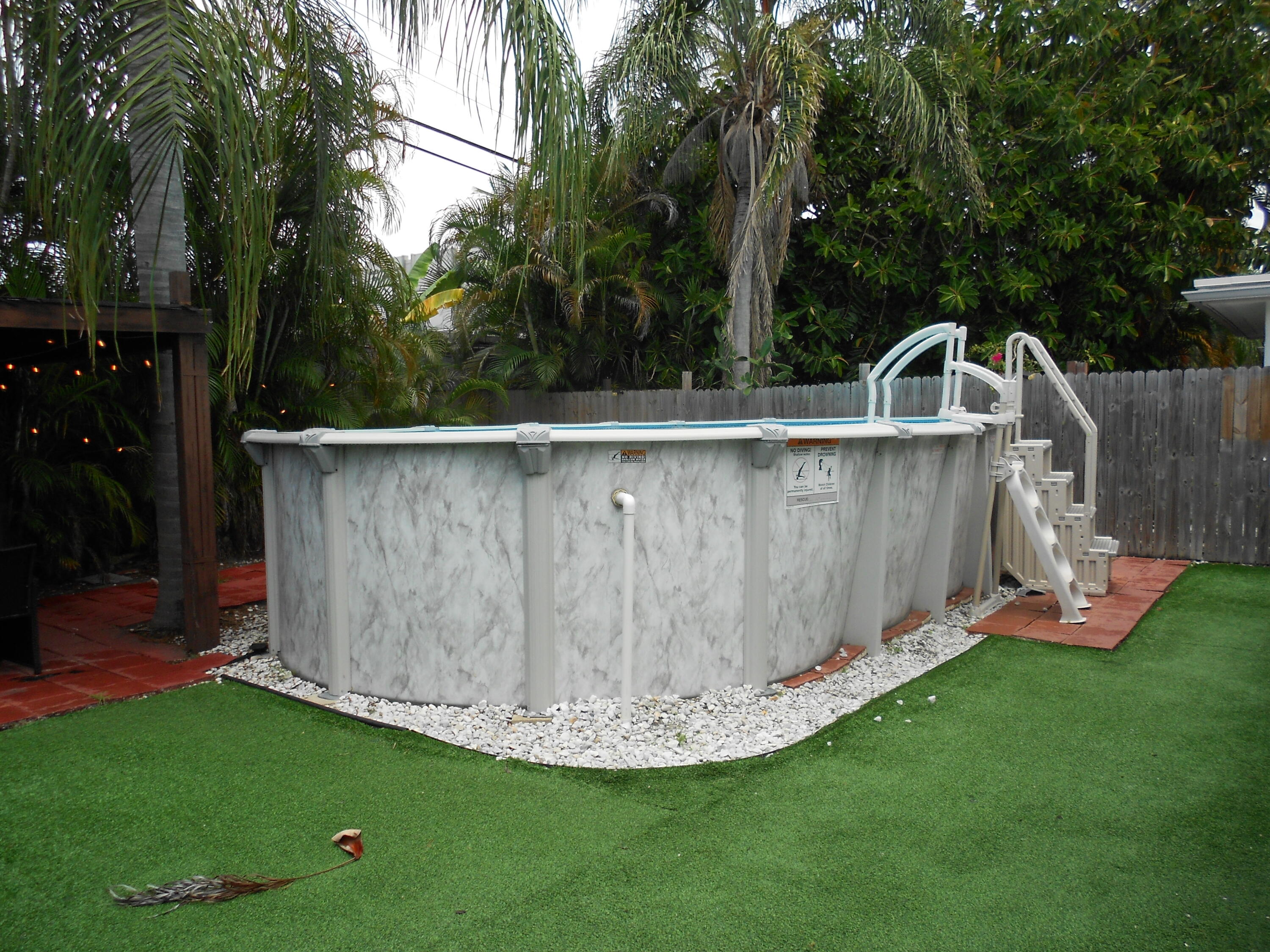 817 Northwest 30th Court Wilton Manors, FL 33311 - Photo 3 of 17 a view of a backyard with plants and a fountain