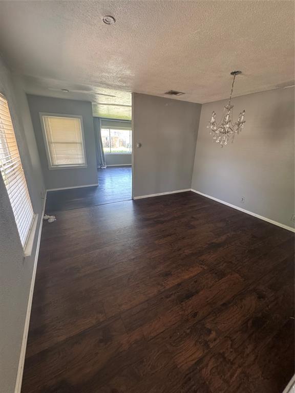 629 Harrison Lane Hurst, TX 76053 - Photo 5 of 20 an empty room with wooden floor and windows