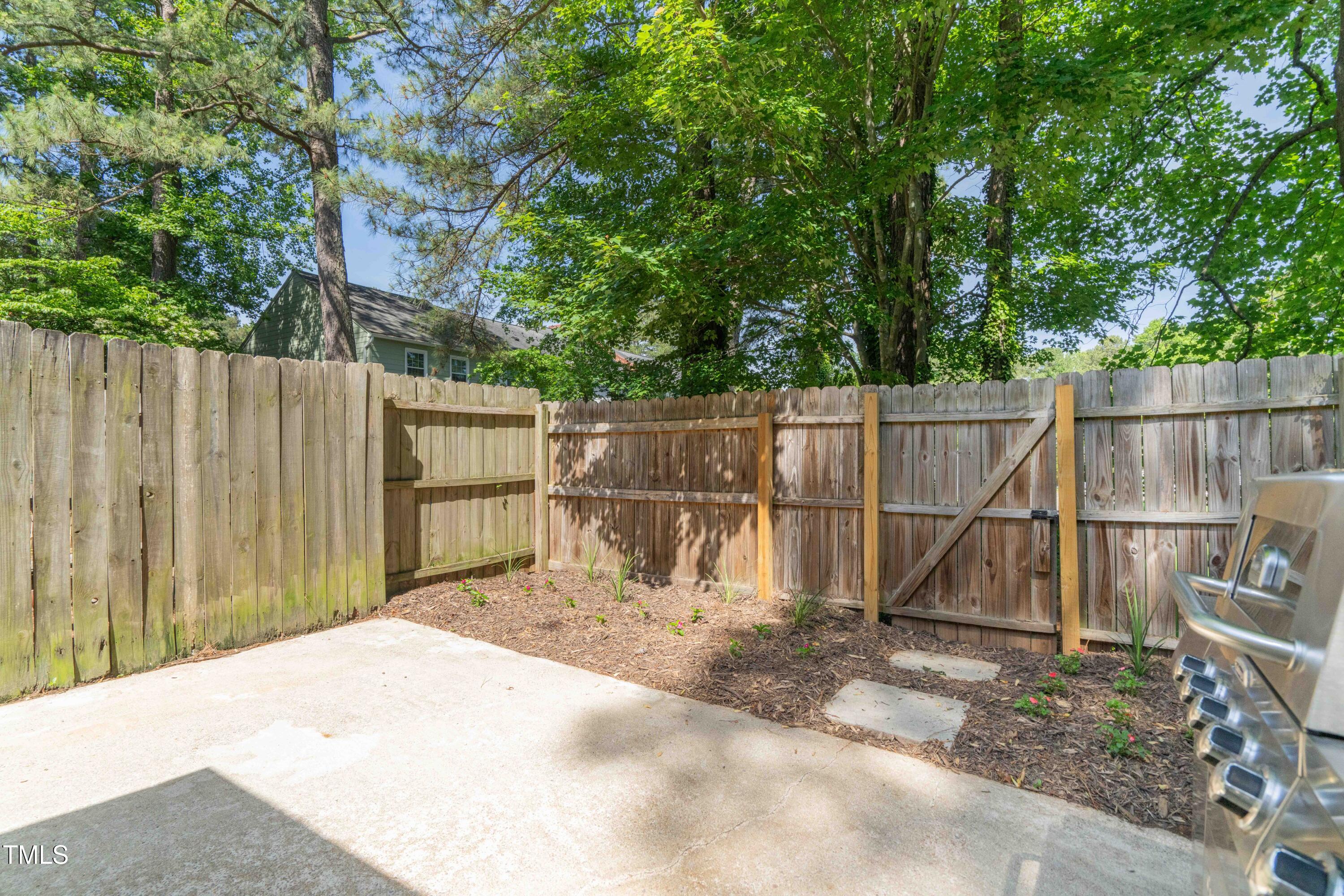 1316 Garden Crest Circle Raleigh, NC 27609 - Photo 15 of 46 a view of a backyard with wooden fence