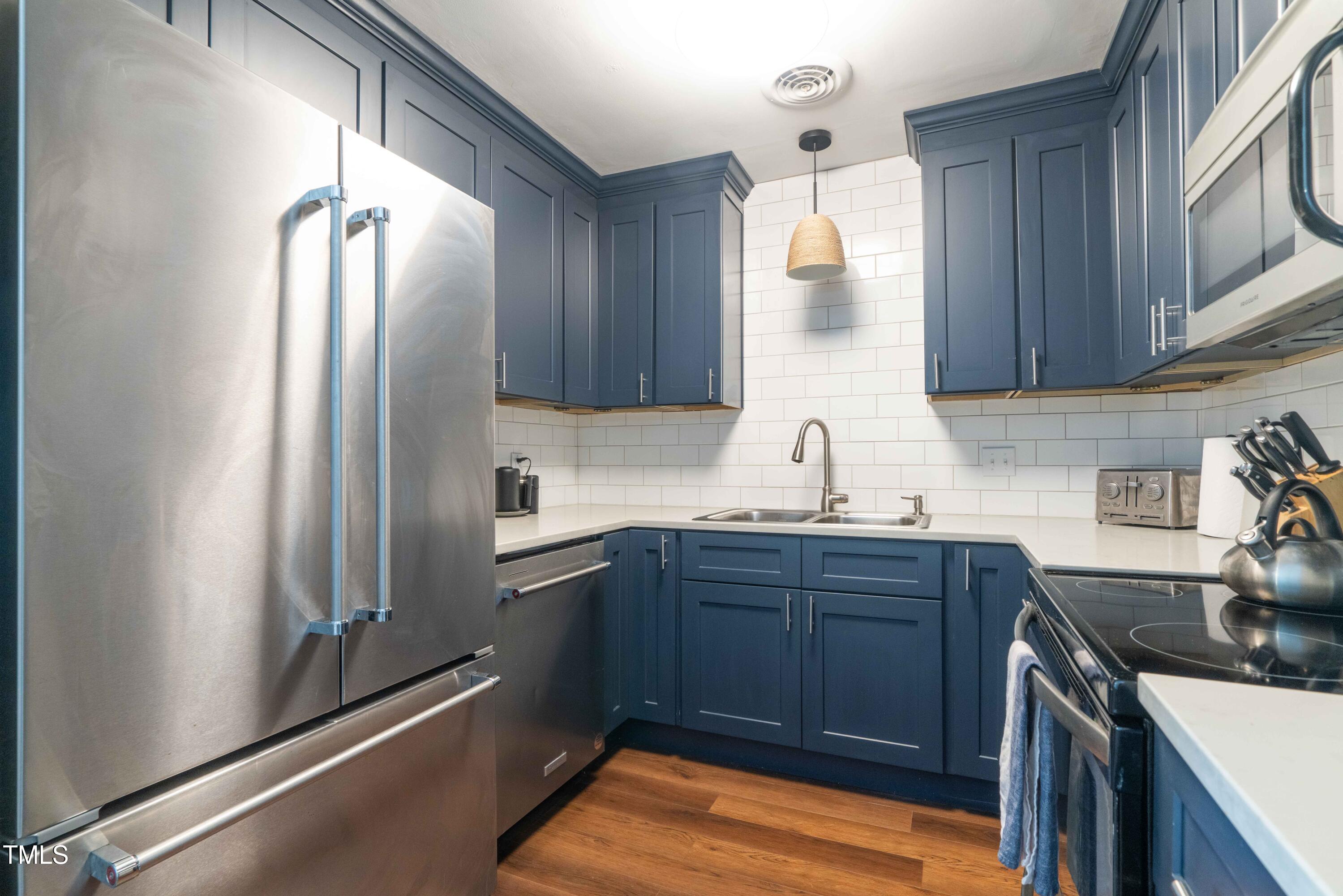 1316 Garden Crest Circle Raleigh, NC 27609 - Photo 17 of 46 a kitchen with stainless steel appliances granite countertop a refrigerator and a sink