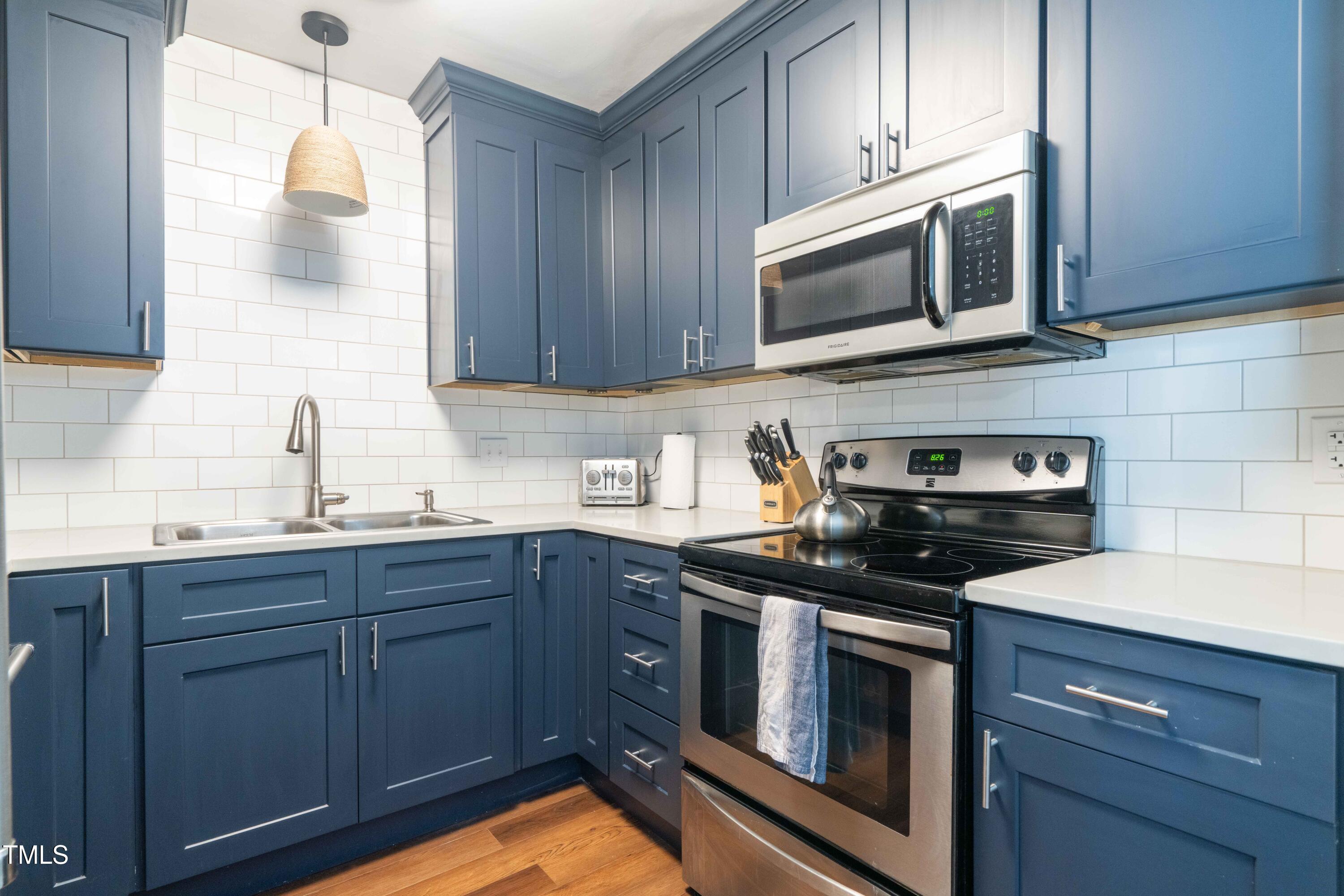 1316 Garden Crest Circle Raleigh, NC 27609 - Photo 18 of 46 a kitchen with stainless steel appliances granite countertop a sink a stove and microwave