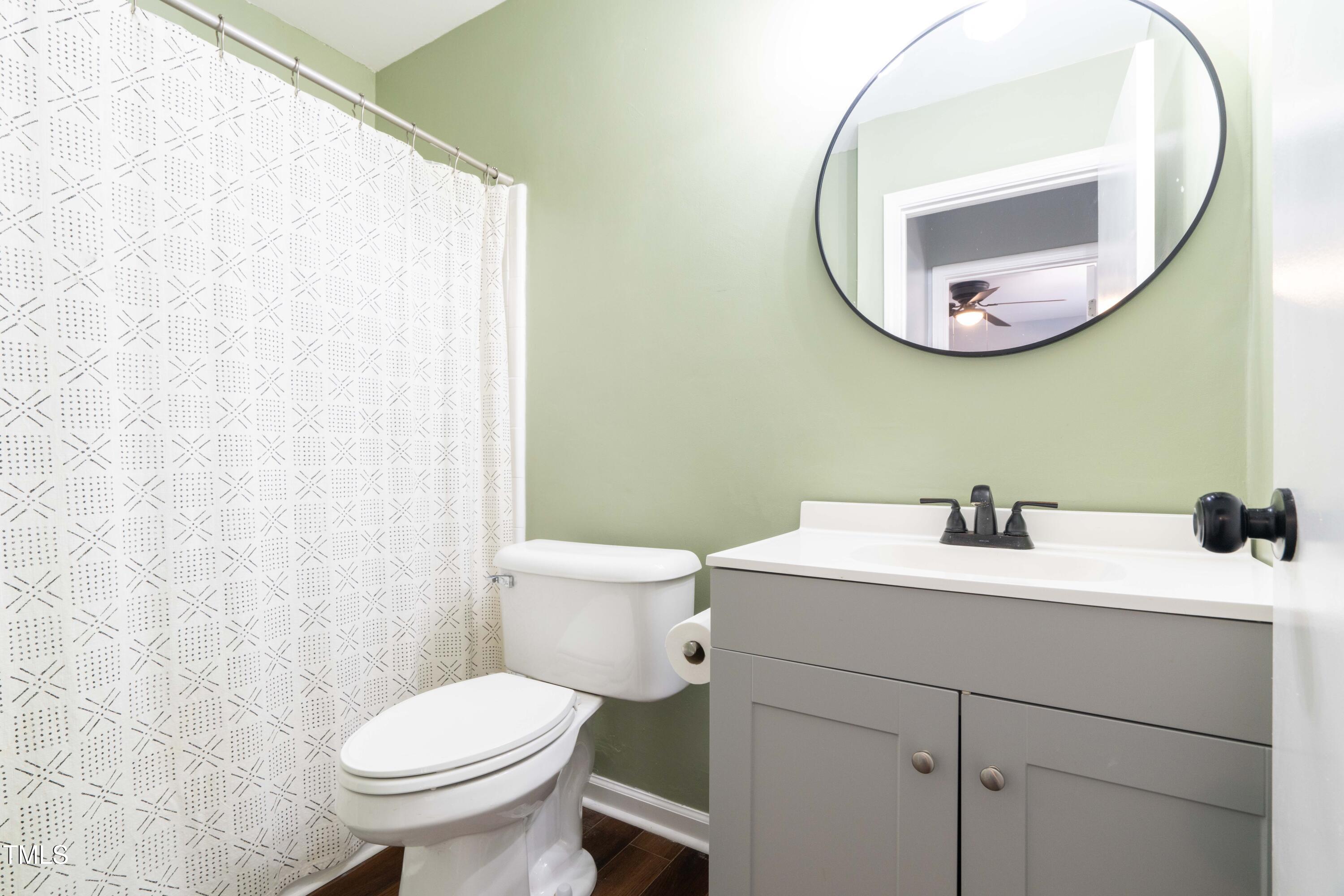 1316 Garden Crest Circle Raleigh, NC 27609 - Photo 24 of 46 a bathroom with a toilet sink and mirror
