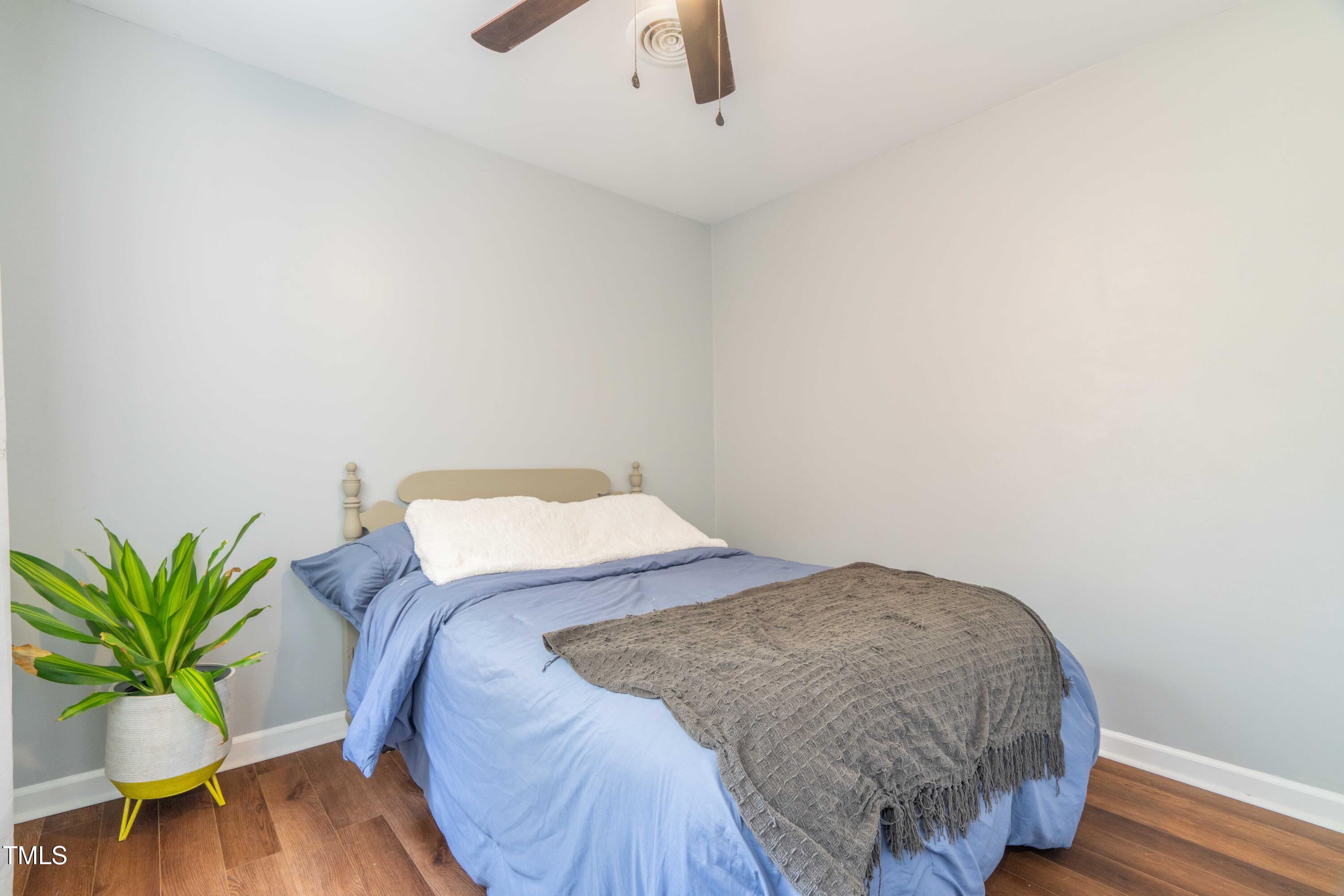 1316 Garden Crest Circle Raleigh, NC 27609 - Photo 26 of 46 a bedroom with a bed and a potted plant