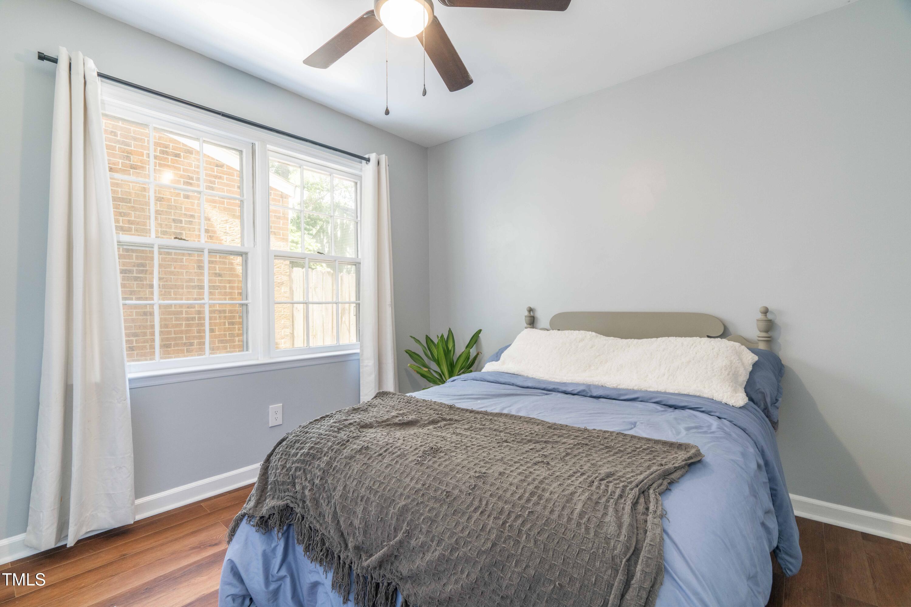 1316 Garden Crest Circle Raleigh, NC 27609 - Photo 27 of 46 a bed sitting in a bedroom next to a window