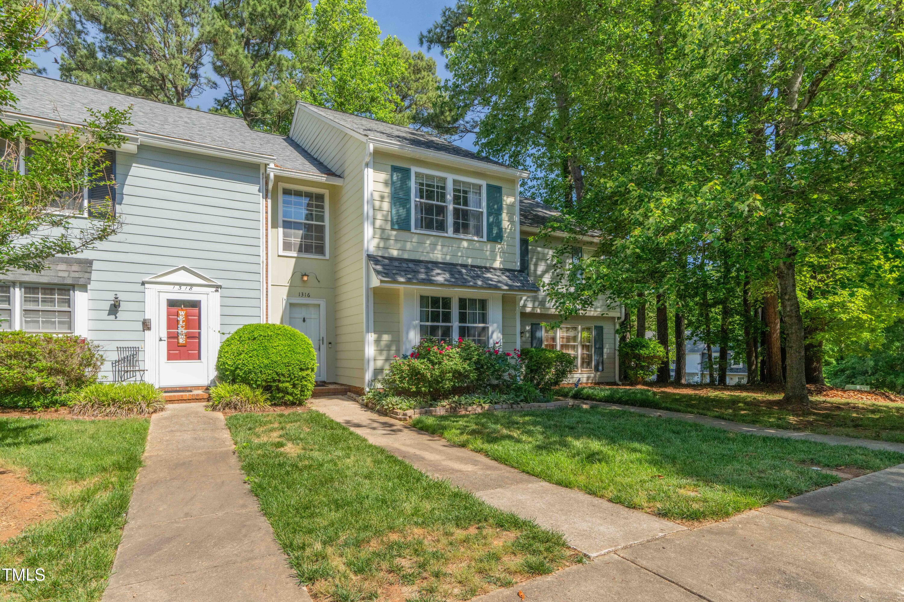 1316 Garden Crest Circle Raleigh, NC 27609 - Photo 2 of 46 a front view of a house with a yard and potted plants