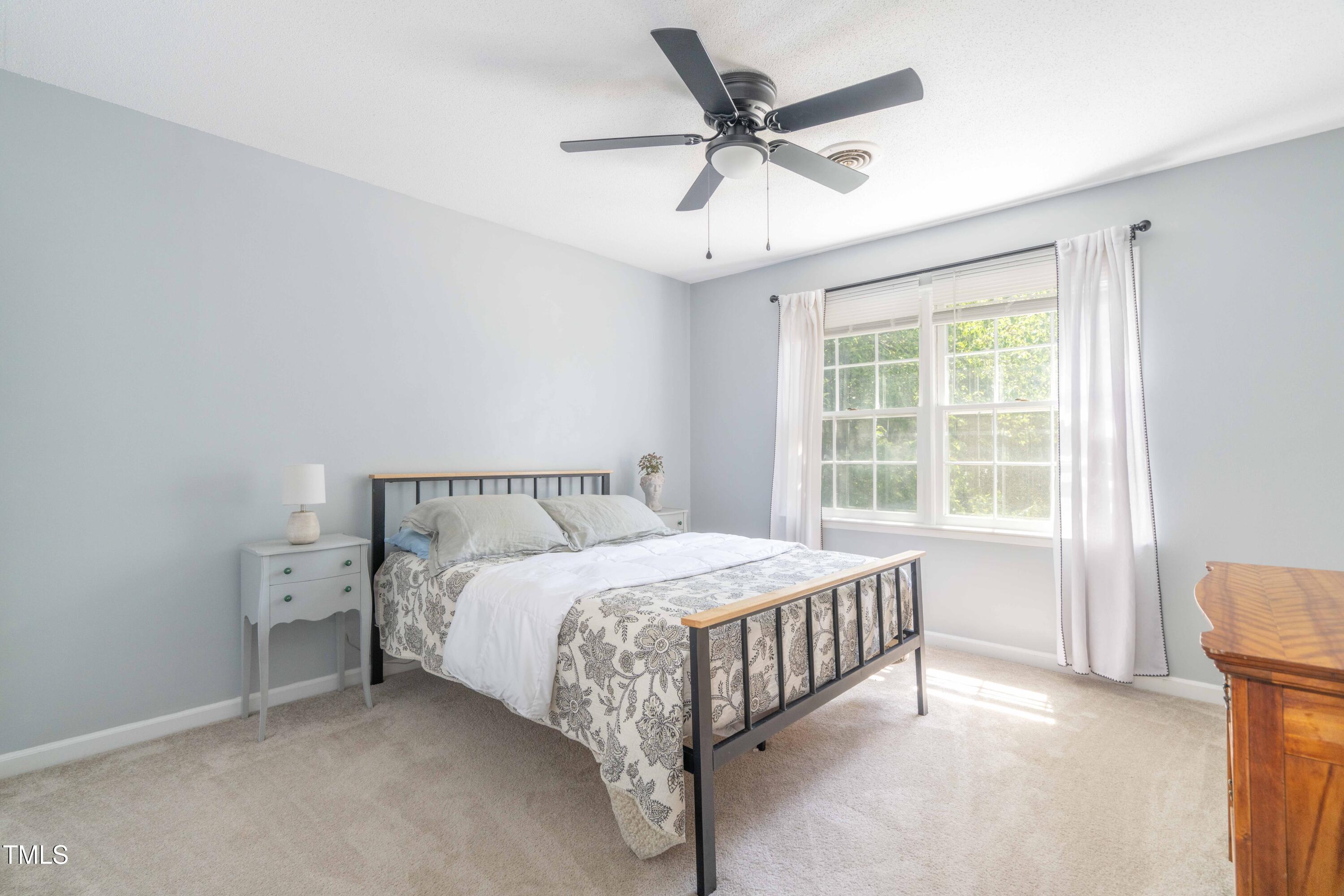 1316 Garden Crest Circle Raleigh, NC 27609 - Photo 33 of 46 a large bed sitting in a bedroom next to a window