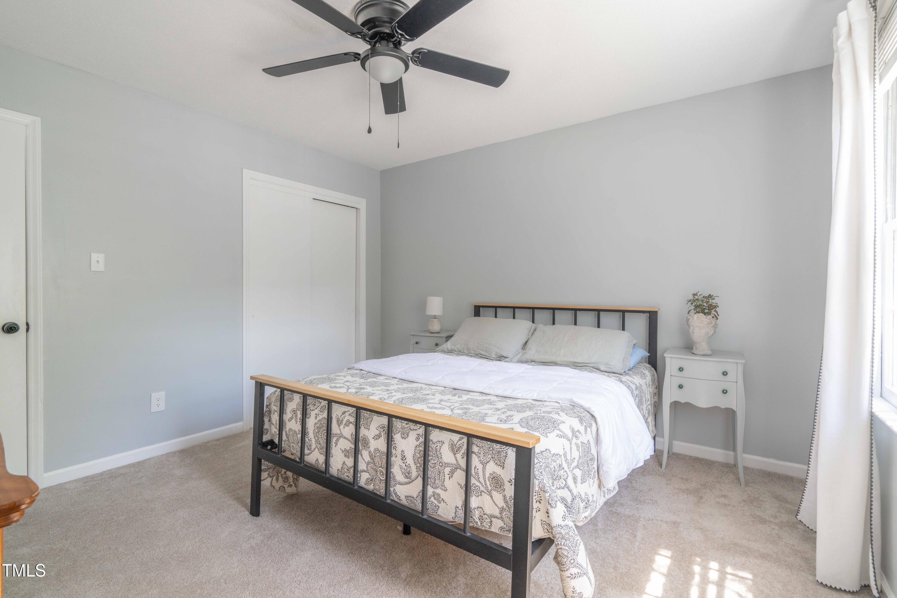 1316 Garden Crest Circle Raleigh, NC 27609 - Photo 34 of 46 a bedroom with a bed and a chandelier fan