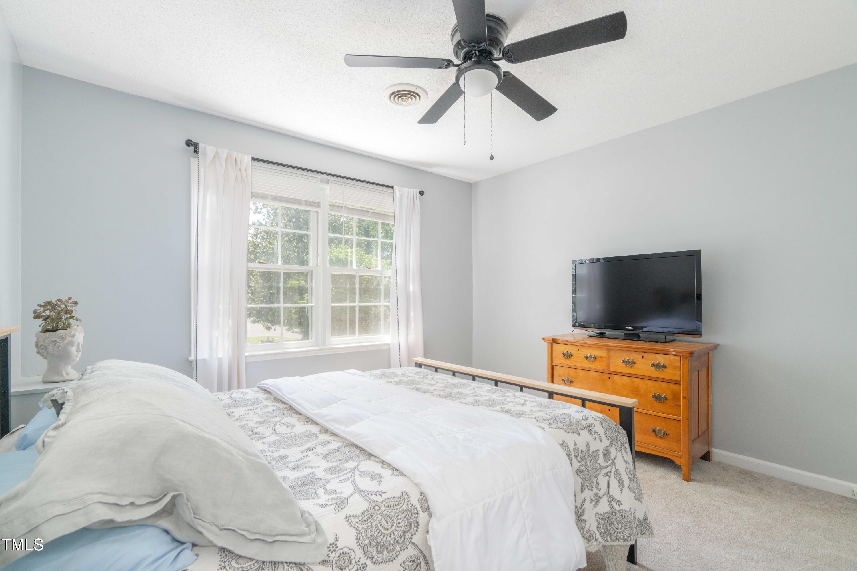 1316 Garden Crest Circle Raleigh, NC 27609 - Photo 35 of 46 a bedroom with a bed and a flat screen tv