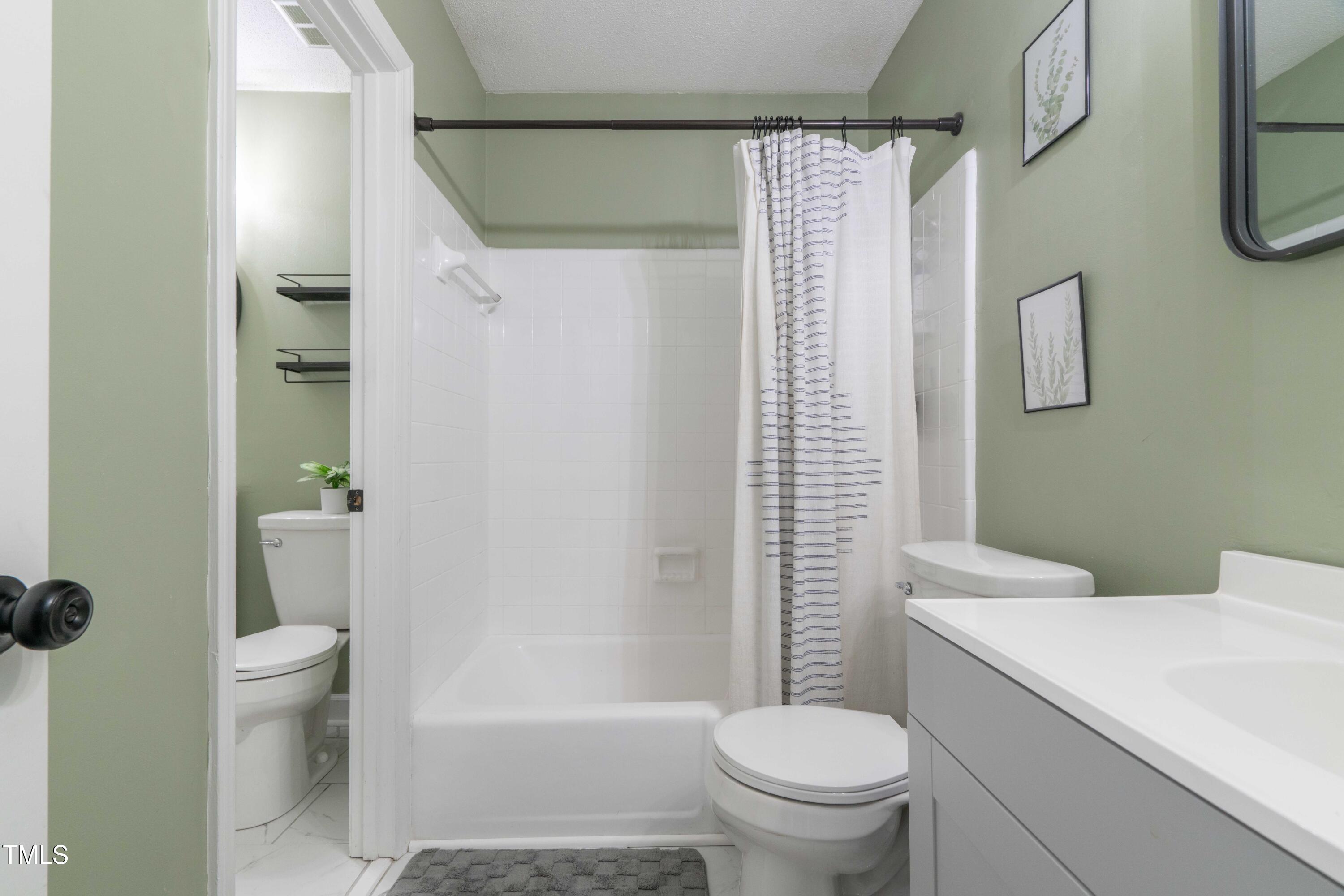 1316 Garden Crest Circle Raleigh, NC 27609 - Photo 37 of 46 a white toilet sitting next to a bathroom sink and a shower