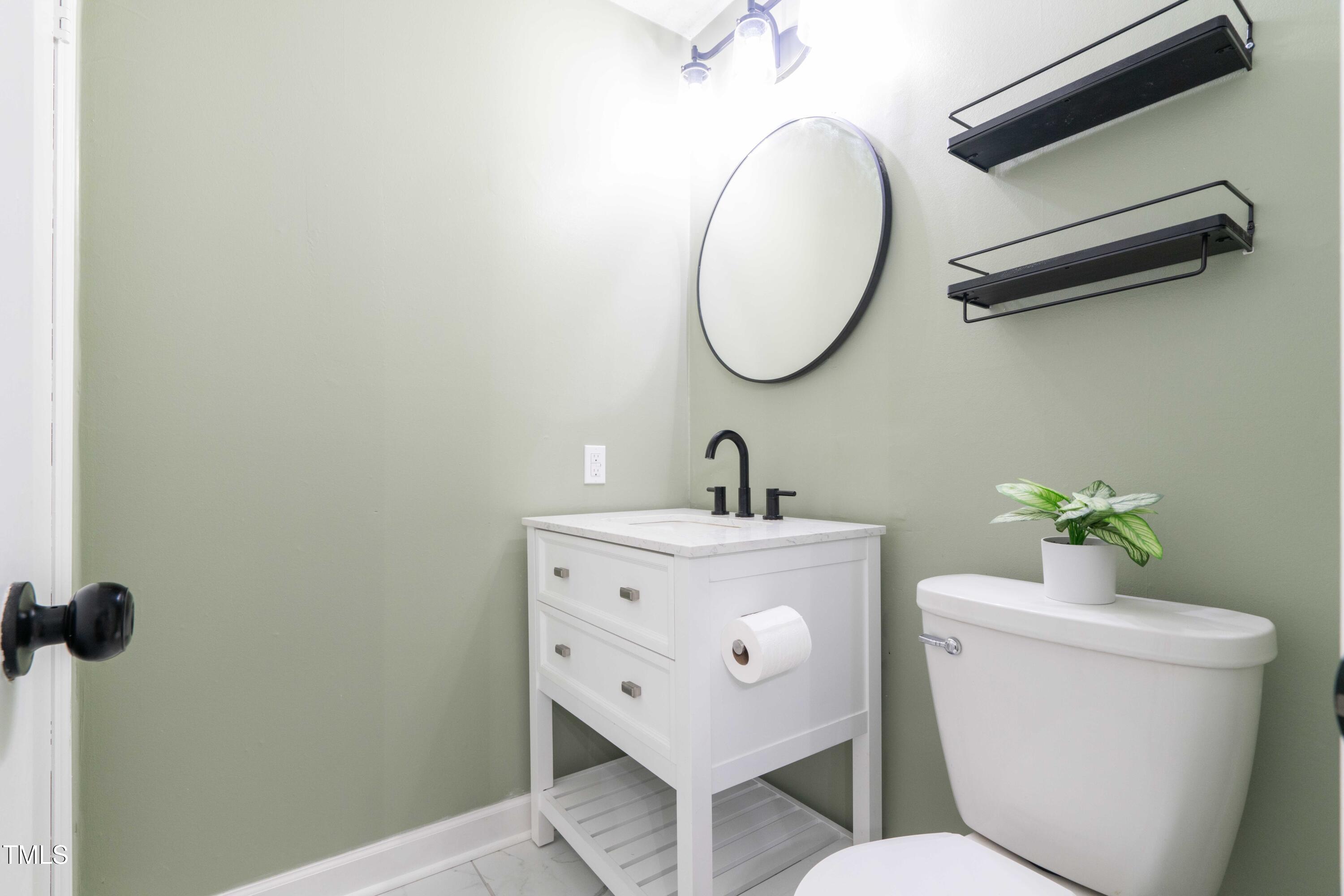 1316 Garden Crest Circle Raleigh, NC 27609 - Photo 40 of 46 a bathroom with a toilet a sink and a mirror