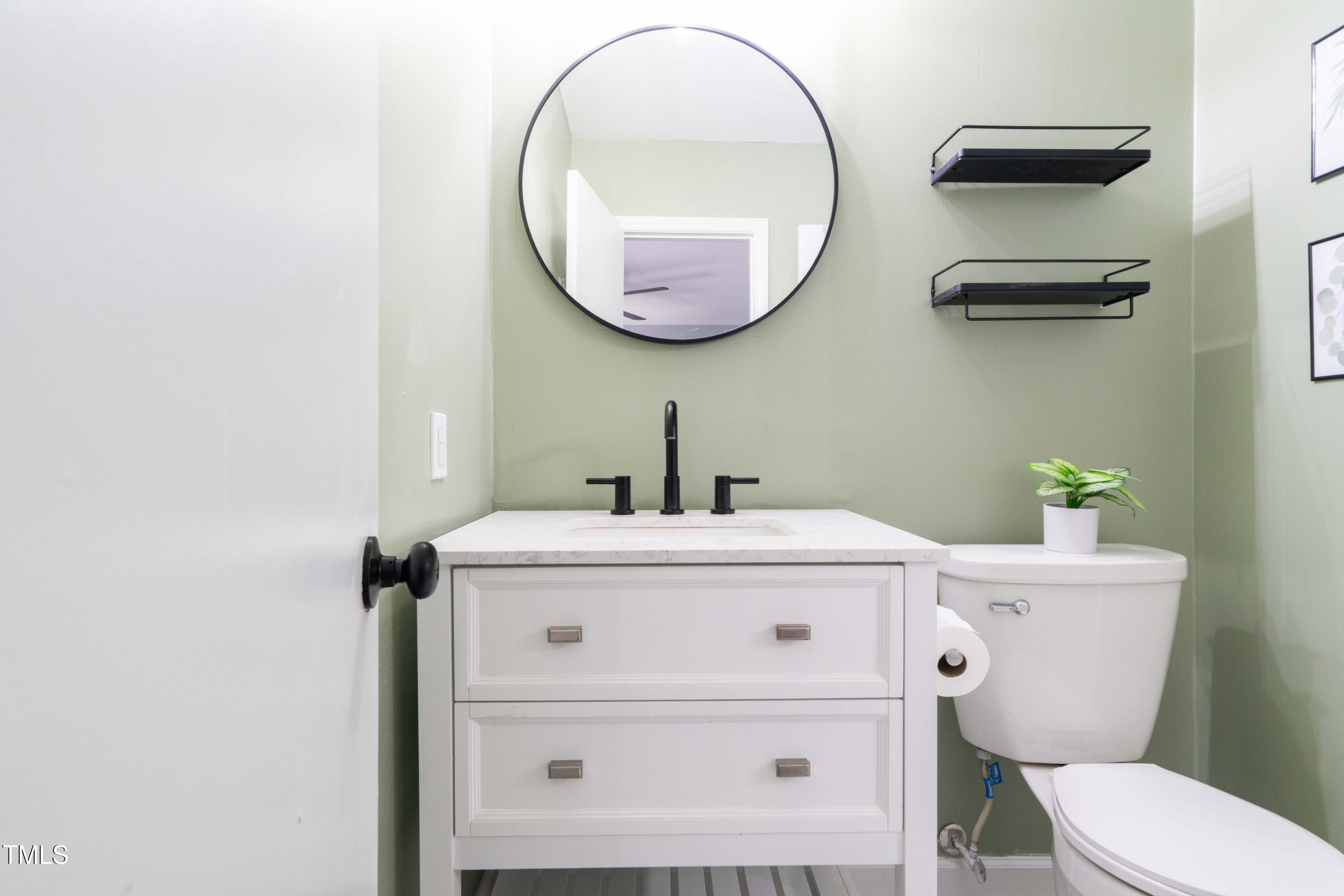1316 Garden Crest Circle Raleigh, NC 27609 - Photo 41 of 46 a bathroom with a sink mirror and toilet