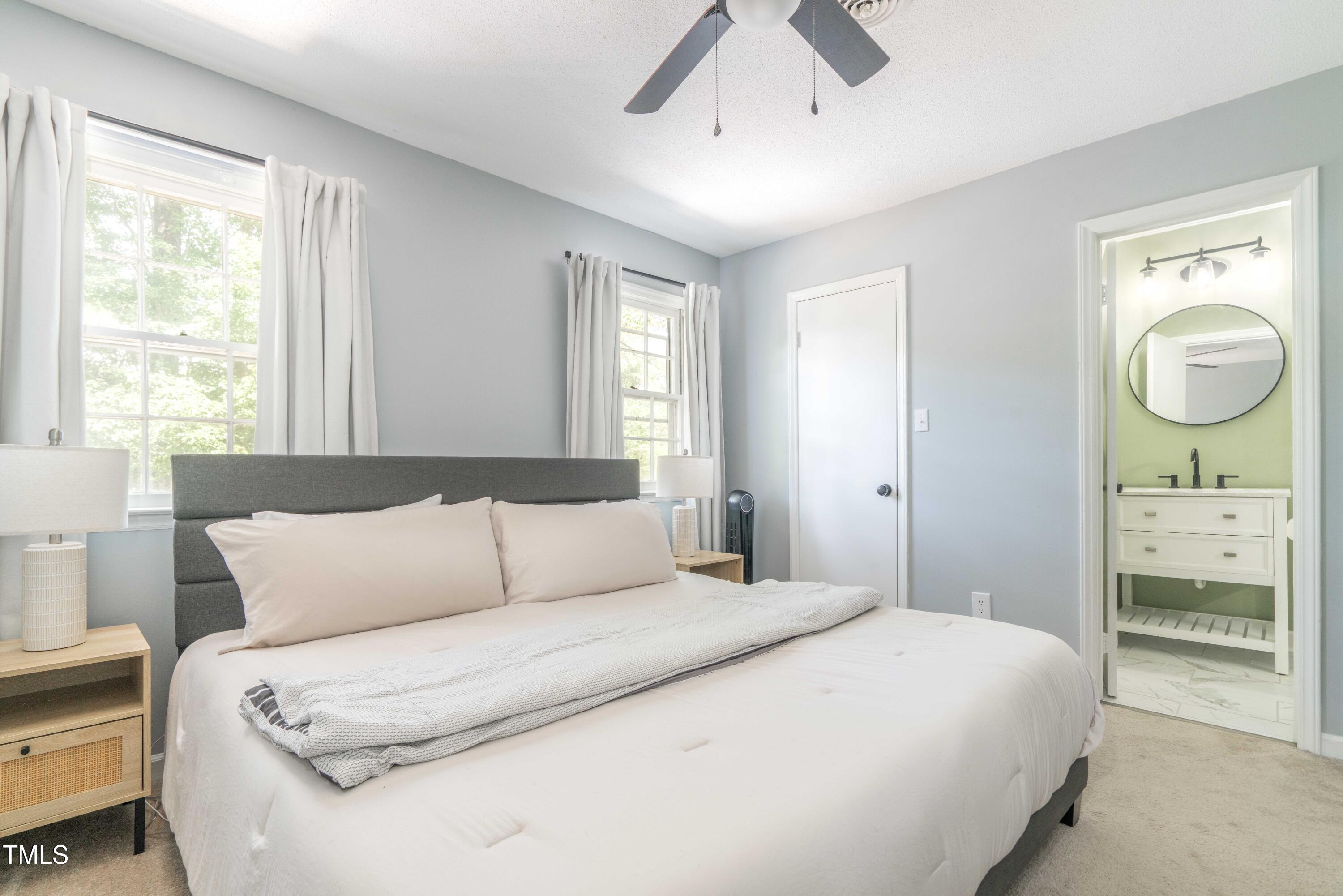 1316 Garden Crest Circle Raleigh, NC 27609 - Photo 44 of 46 a bedroom with a bed mirror and a window