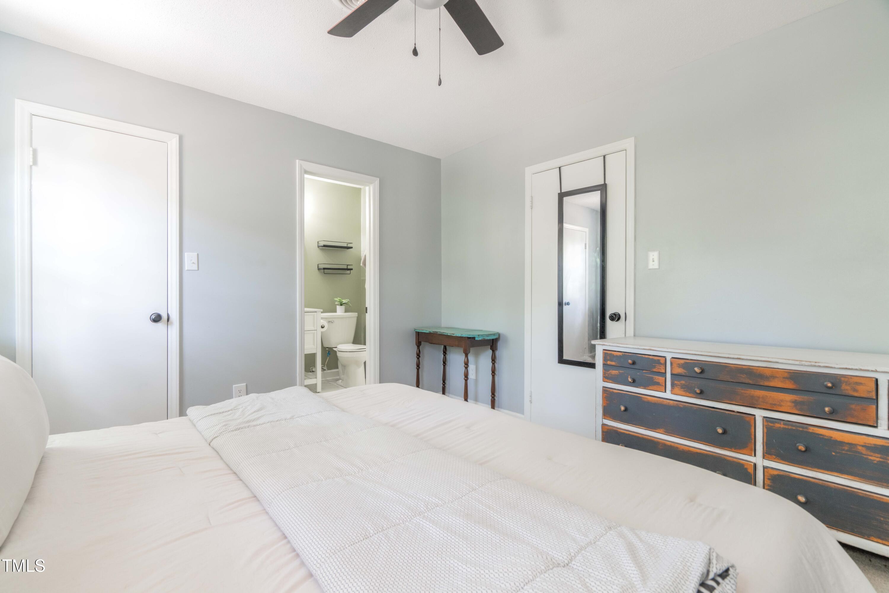 1316 Garden Crest Circle Raleigh, NC 27609 - Photo 45 of 46 a bedroom with a bed and a chandelier