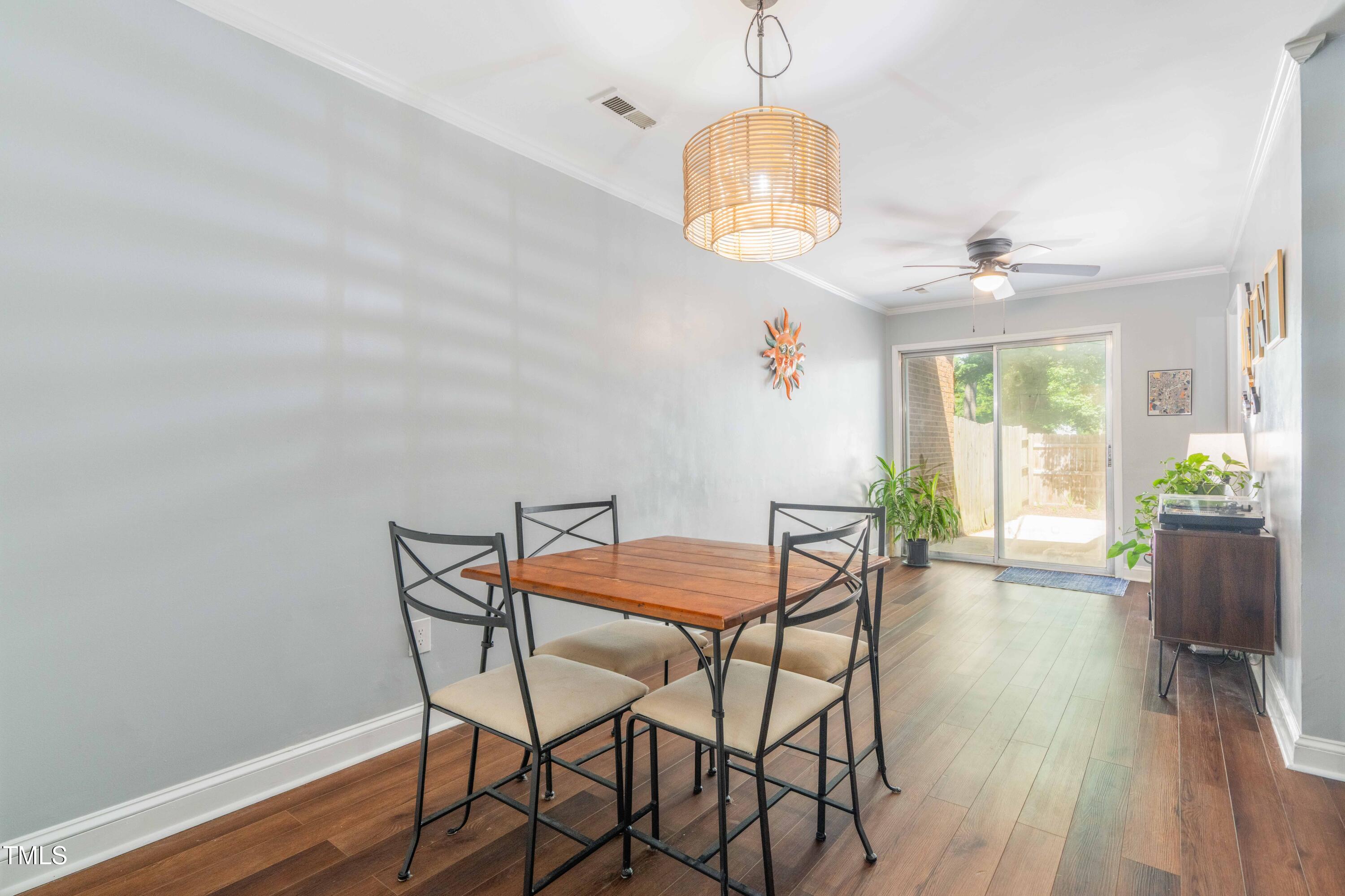 1316 Garden Crest Circle Raleigh, NC 27609 - Photo 8 of 46 a view of a dining room with furniture wooden floor and chandelier