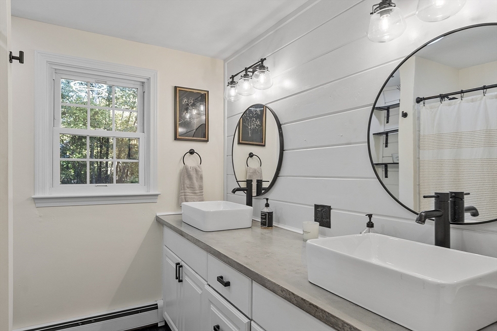 8 Country Road Lunenburg, MA 01462 - Photo 12 of 42 a bathroom with a double vanity sink and a mirror