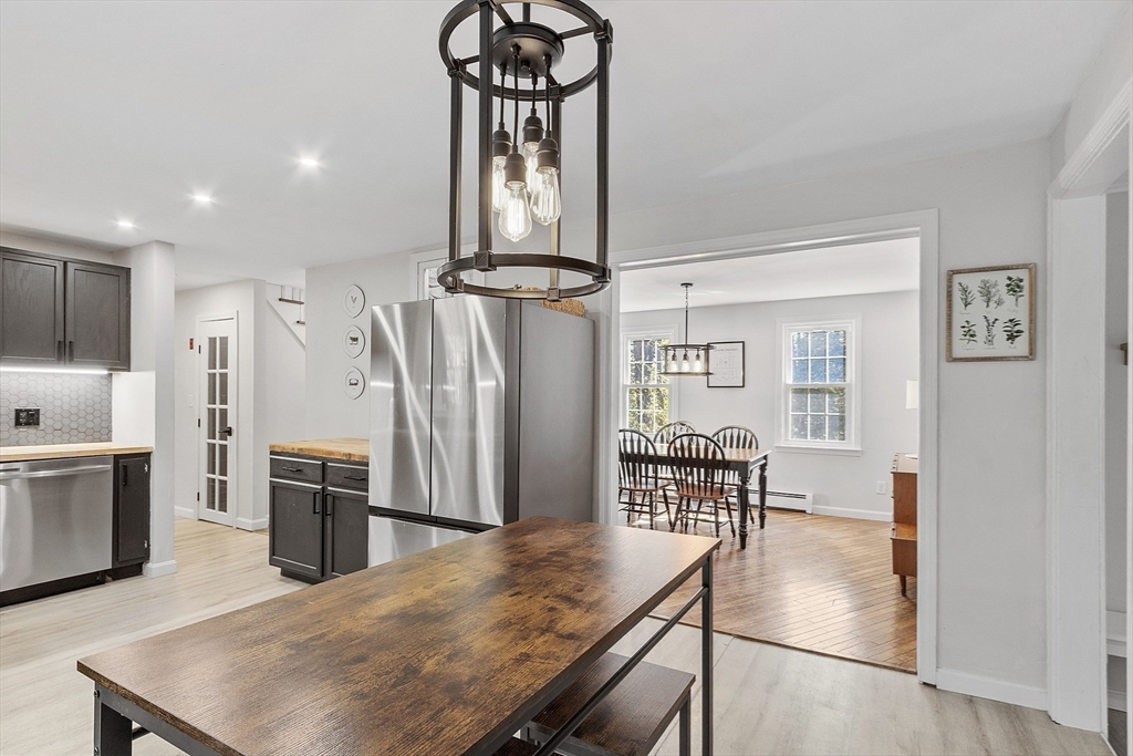 8 Country Road Lunenburg, MA 01462 - Photo 24 of 42 a kitchen with stainless steel appliances kitchen island granite countertop a refrigerator a stove a microwave oven a sink with island and chairs