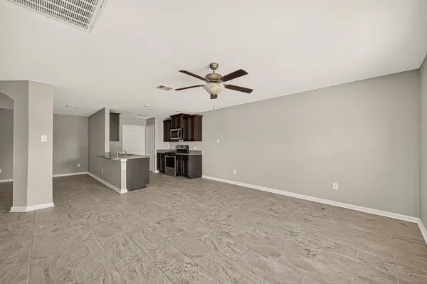 a view of kitchen with microwave and cabinets