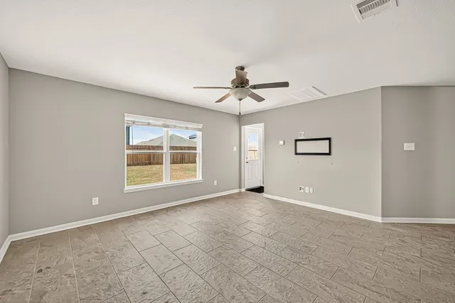 a view of an empty room with a window