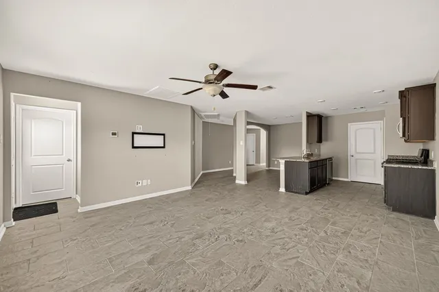 a view of a livingroom with a kitchen