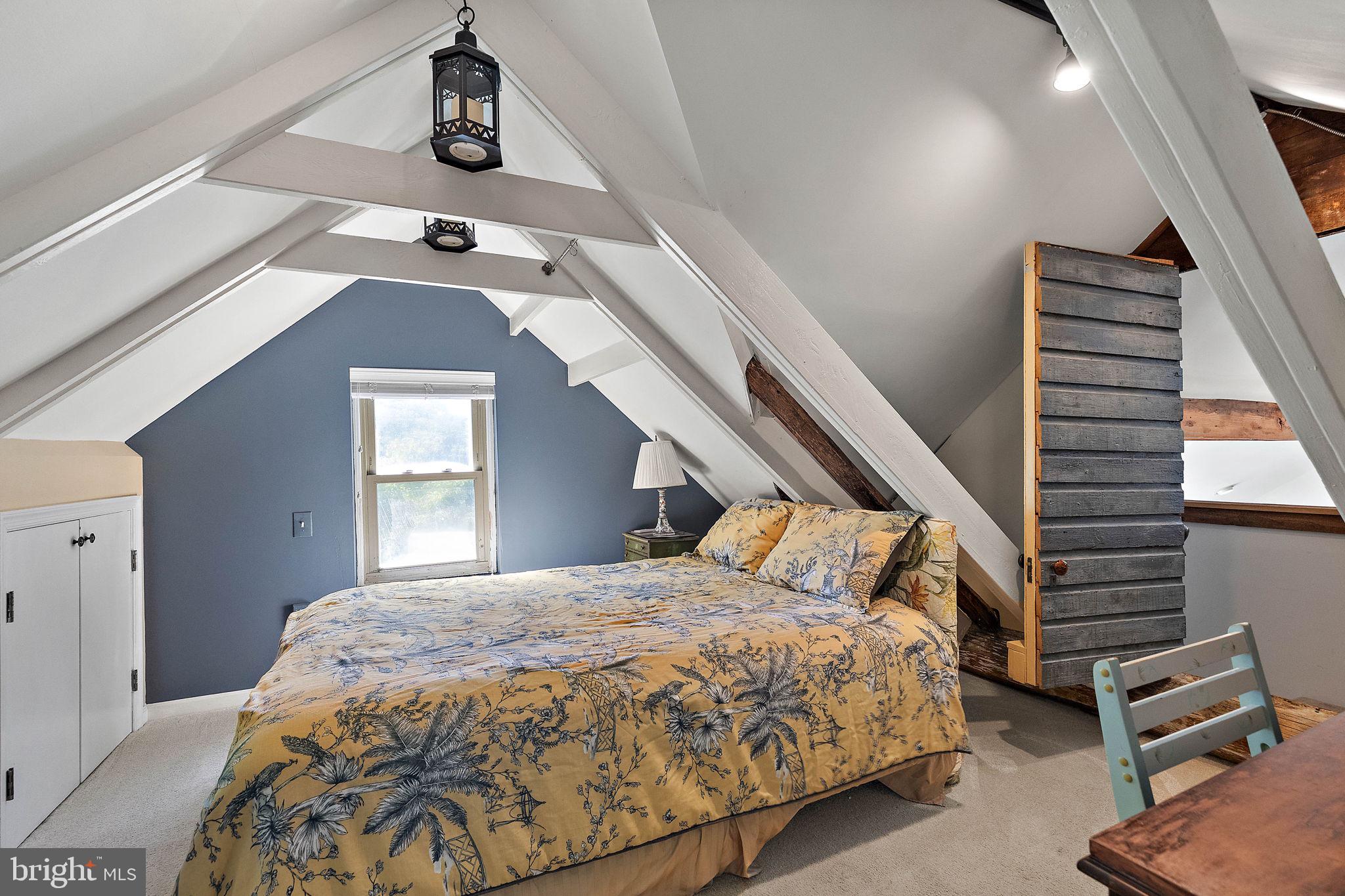 126 Ridge Road Chadds Ford, PA 19317 - Photo 15 of 64 a bedroom with a bed and a chandelier