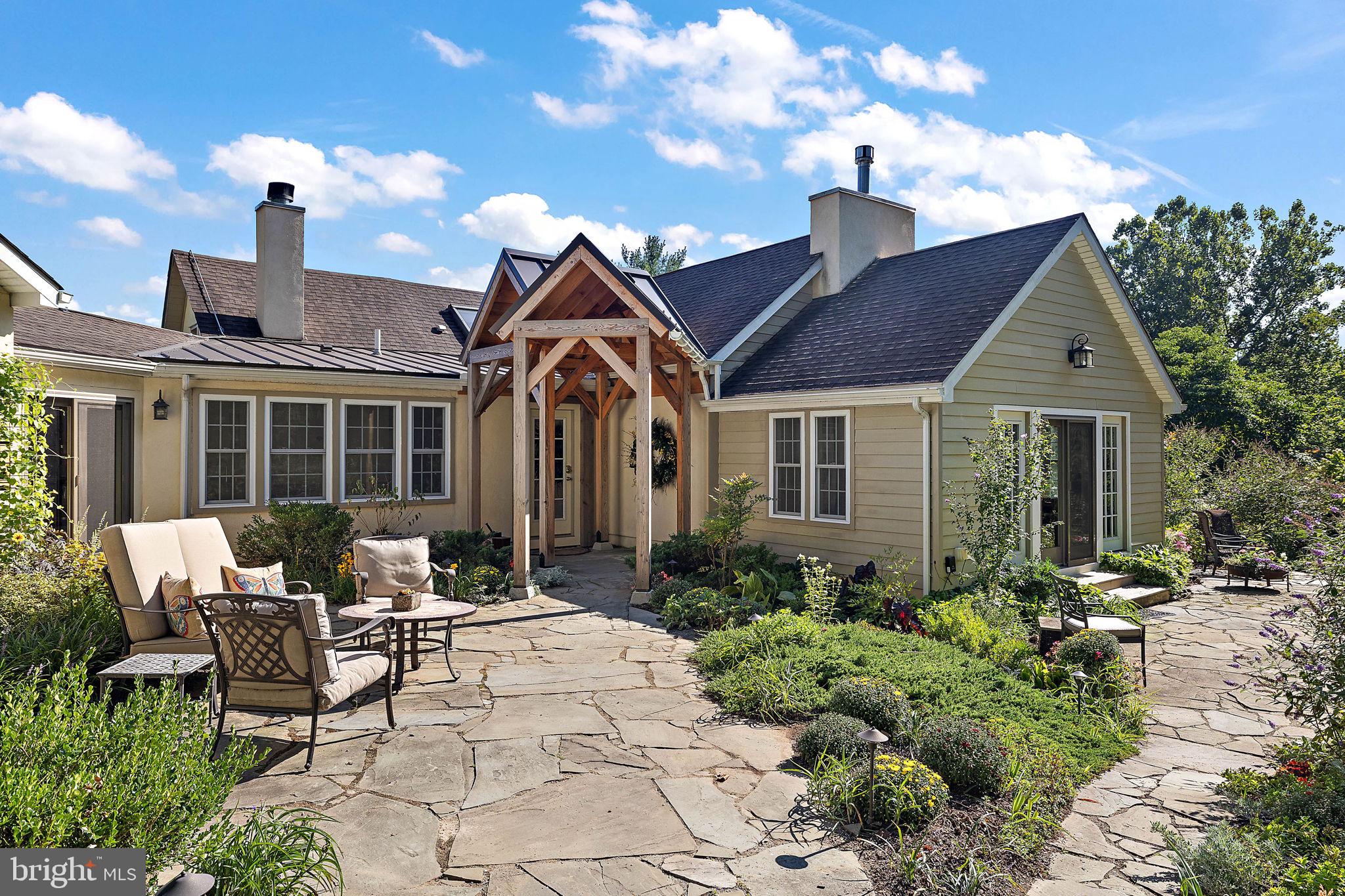 126 Ridge Road Chadds Ford, PA 19317 - Photo 2 of 64 a house view with a seating space and garden