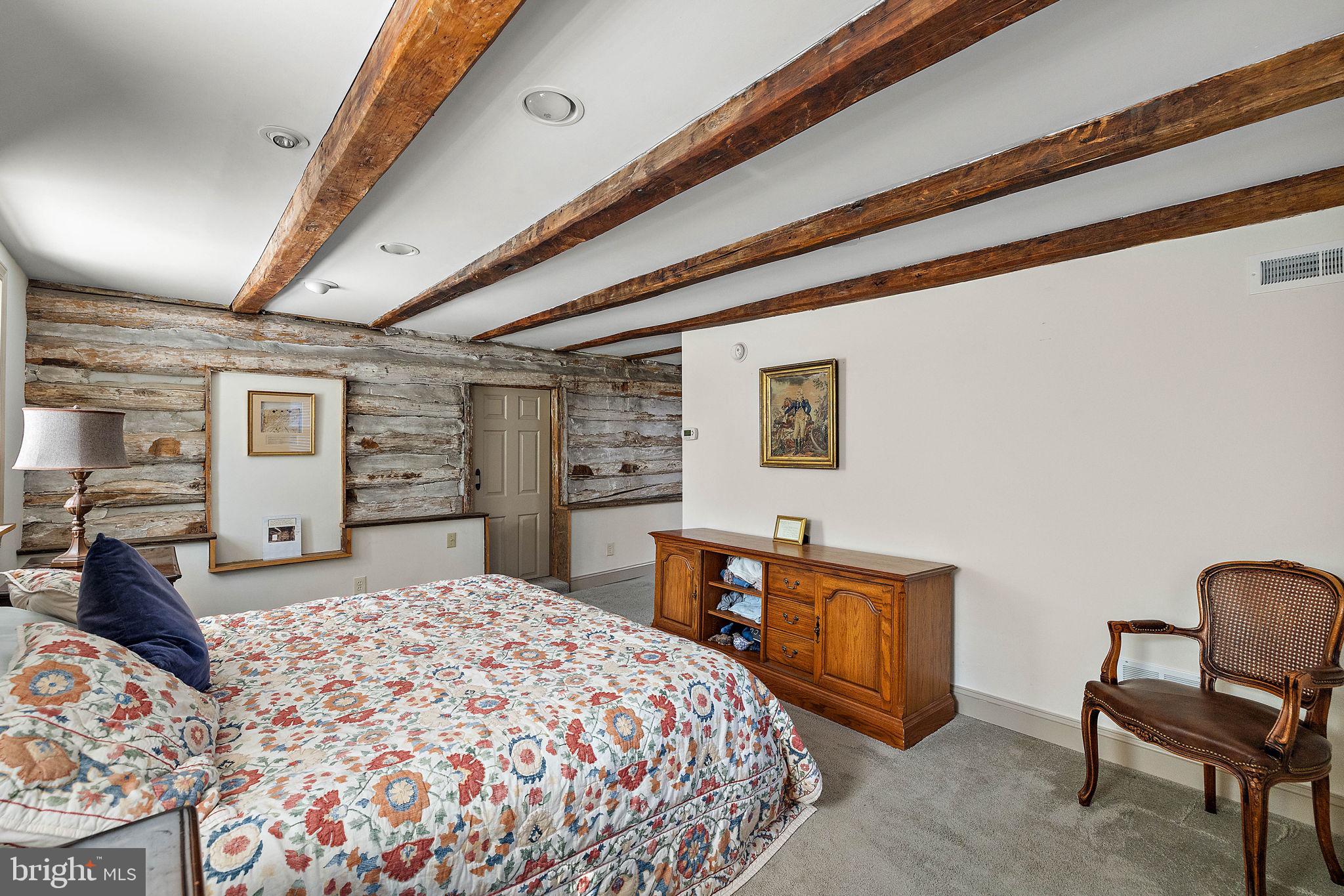 126 Ridge Road Chadds Ford, PA 19317 - Photo 24 of 64 a bedroom with a large bed a dresser and chair