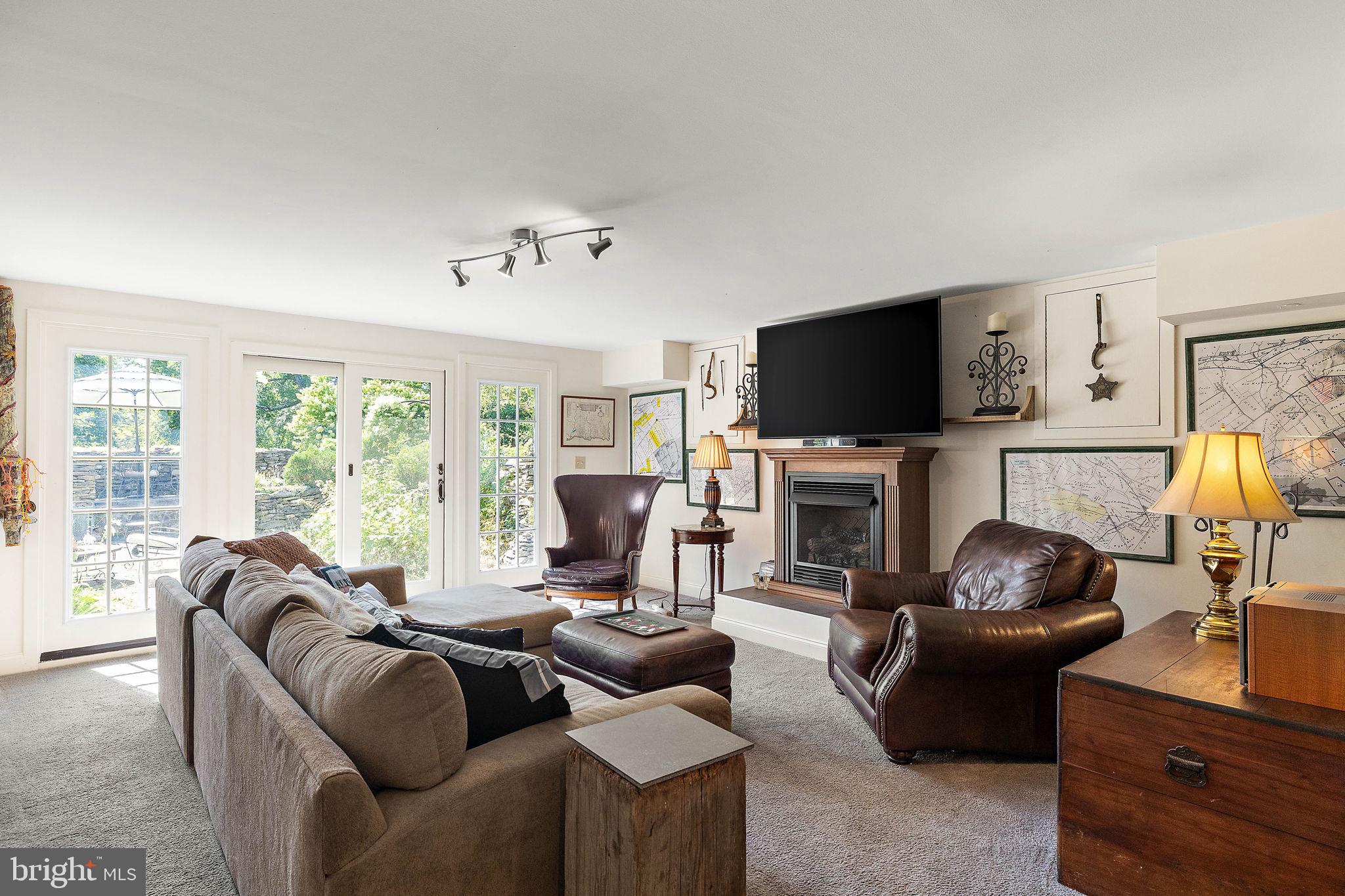 126 Ridge Road Chadds Ford, PA 19317 - Photo 35 of 64 a living room with furniture a fireplace and a flat screen tv