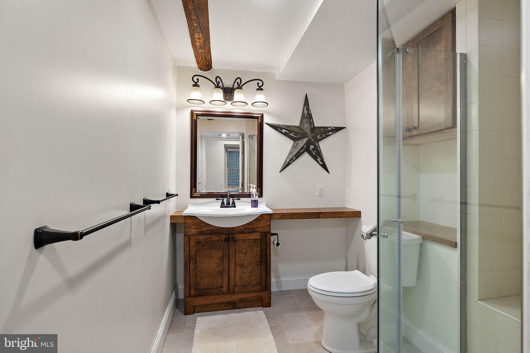 126 Ridge Road Chadds Ford, PA 19317 - Photo 39 of 64 a bathroom with a toilet sink and mirror