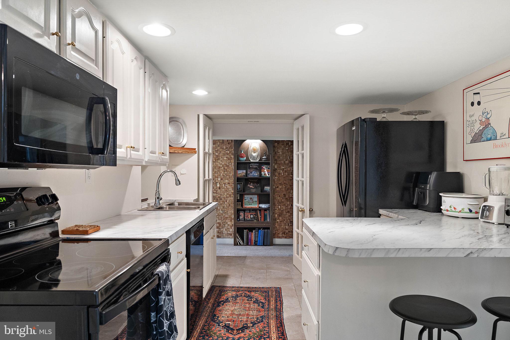 126 Ridge Road Chadds Ford, PA 19317 - Photo 44 of 64 a kitchen with stainless steel appliances kitchen island granite countertop a refrigerator and a stove top oven