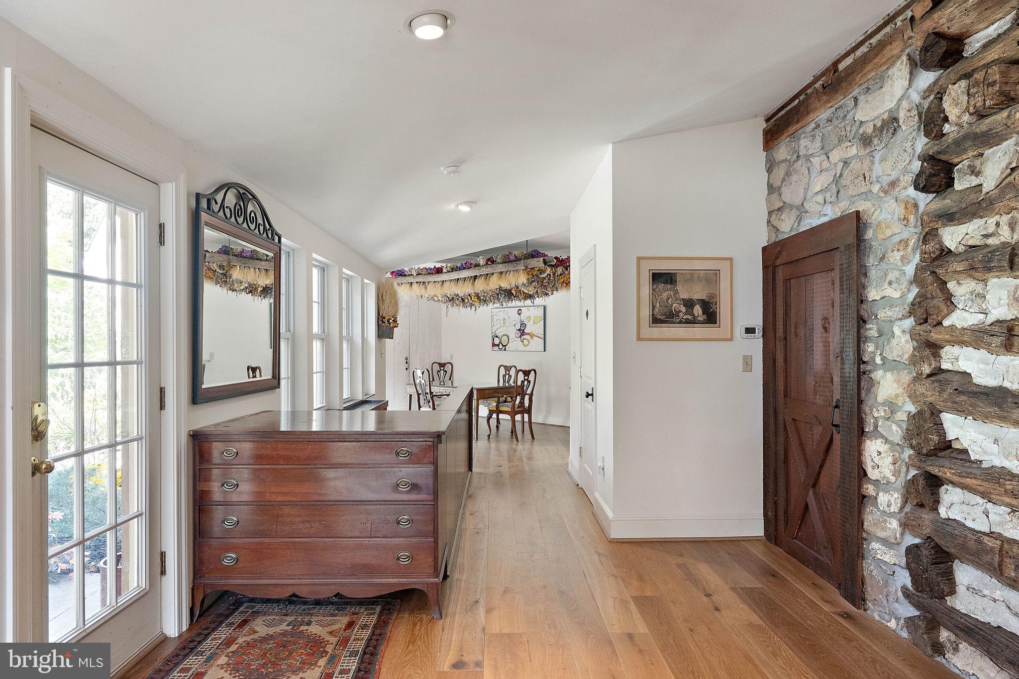 126 Ridge Road Chadds Ford, PA 19317 - Photo 8 of 64 a view of a hallway to room with wooden floor and windows