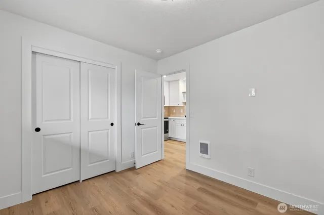 a bathroom with a toilet sink vanity tub and mirror