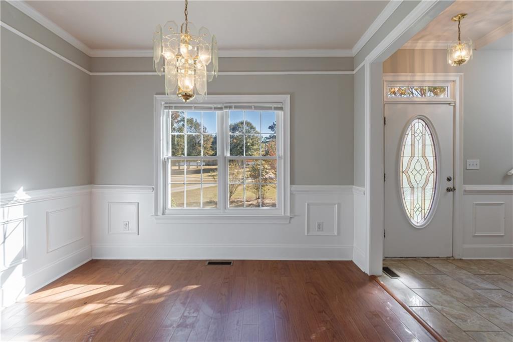 6790 Palace Lane Fairburn, GA 30213 - Photo 15 of 62 an empty room with wooden floor cabinet and windows