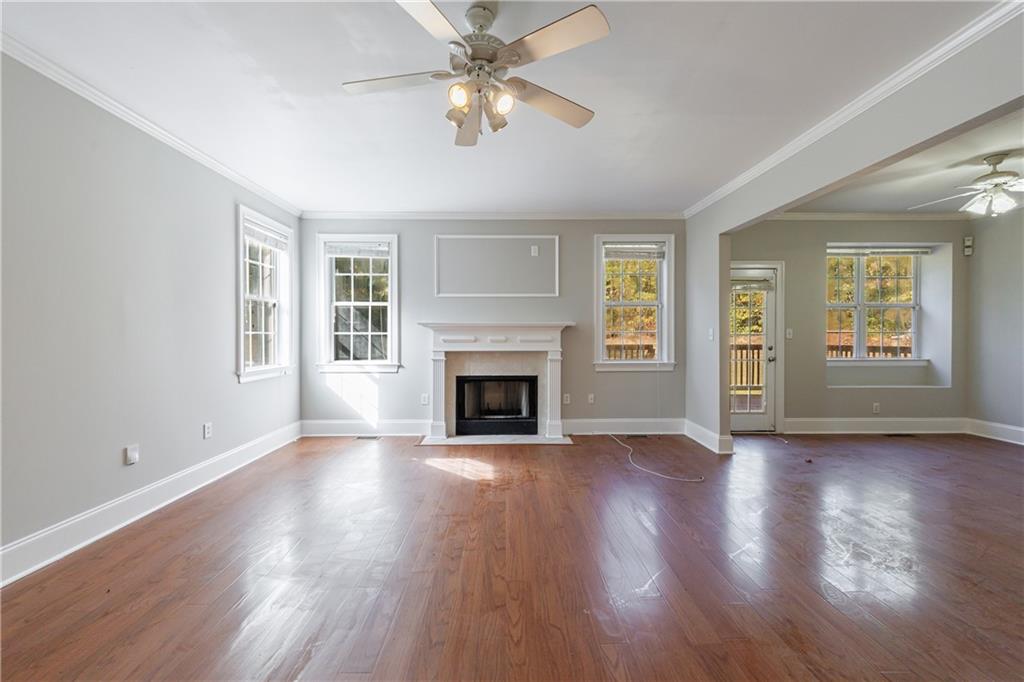 6790 Palace Lane Fairburn, GA 30213 - Photo 18 of 62 a view of an empty room with window and wooden floor