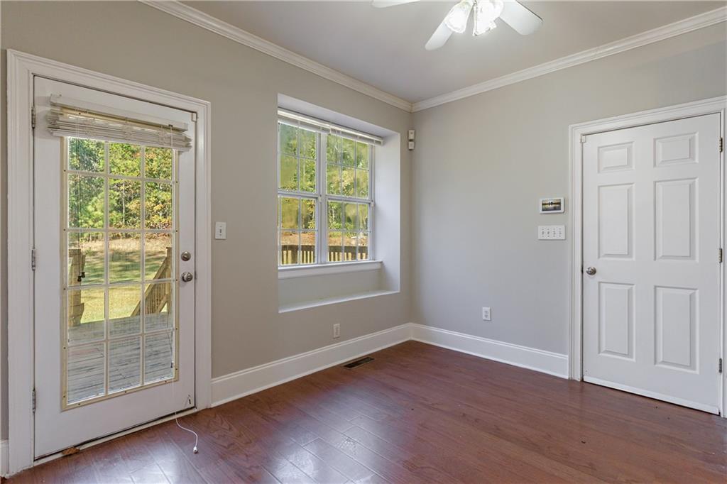 6790 Palace Lane Fairburn, GA 30213 - Photo 23 of 62 an empty room with wooden floor and windows