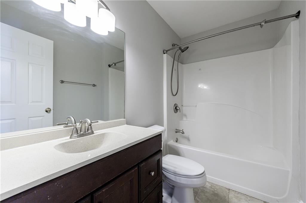 6790 Palace Lane Fairburn, GA 30213 - Photo 32 of 62 a bathroom with a sink a toilet and a mirror