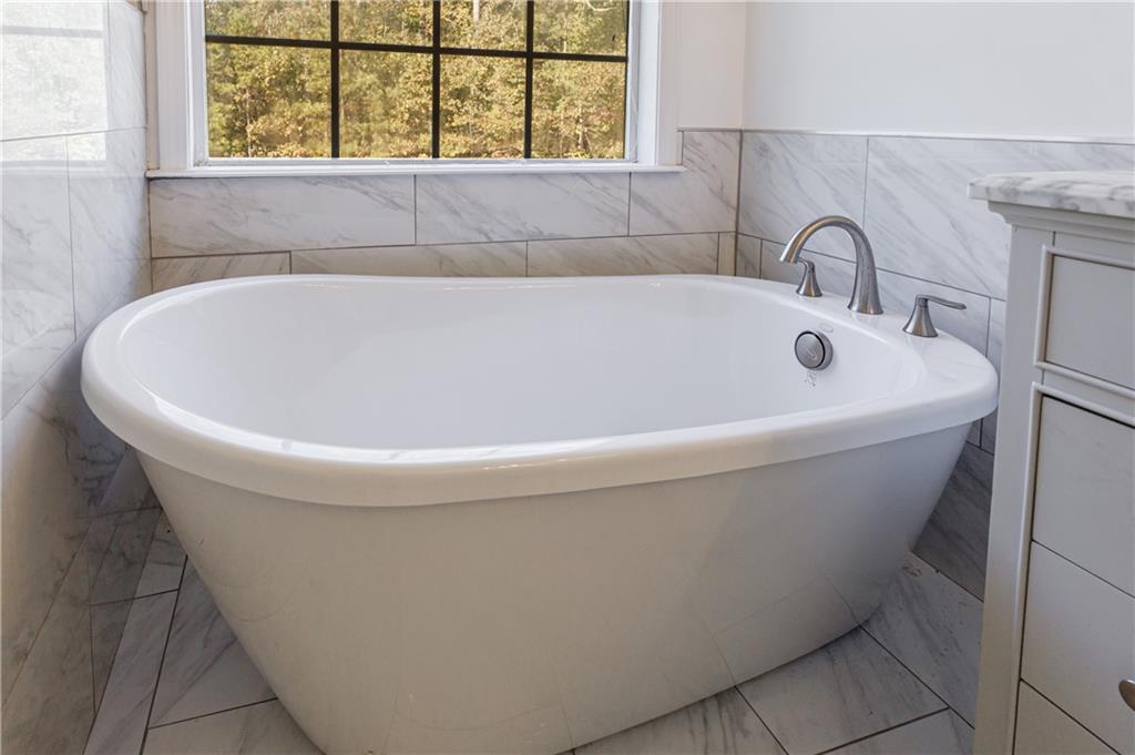 6790 Palace Lane Fairburn, GA 30213 - Photo 37 of 62 a white bath tub sitting next to a window