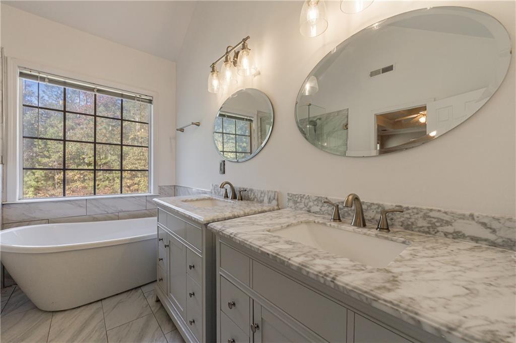 6790 Palace Lane Fairburn, GA 30213 - Photo 39 of 62 a bathroom with a granite countertop sink mirror and bathtub