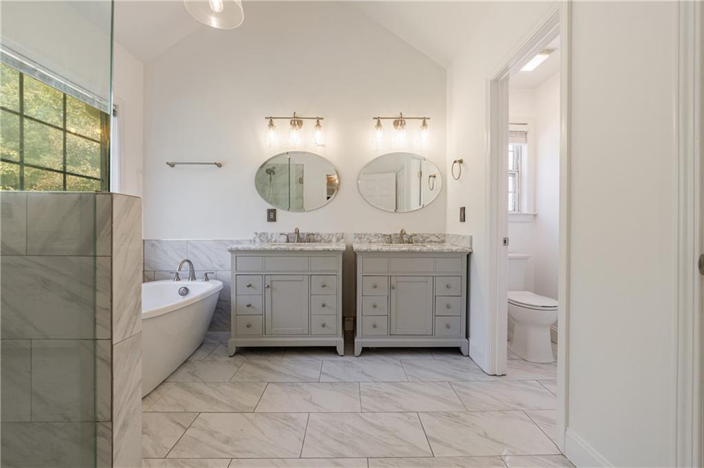 6790 Palace Lane Fairburn, GA 30213 - Photo 40 of 62 a spacious bathroom with a double vanity sink toilet mirror and bathtub