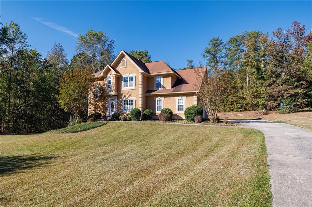 6790 Palace Lane Fairburn, GA 30213 - Photo 4 of 62 a front view of a house with a yard and trees