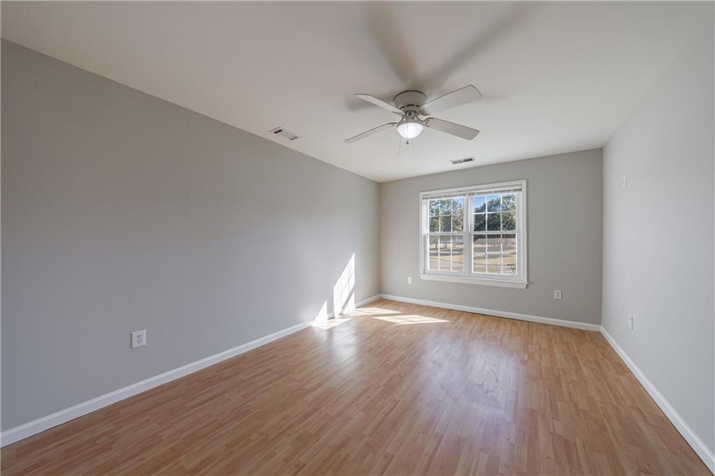 6790 Palace Lane Fairburn, GA 30213 - Photo 44 of 62 a view of an empty room with wooden floor and a window