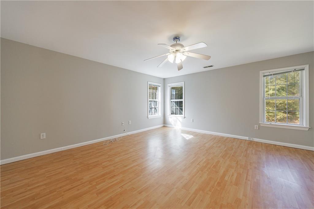 6790 Palace Lane Fairburn, GA 30213 - Photo 47 of 62 a view of an empty room with a window and wooden floor