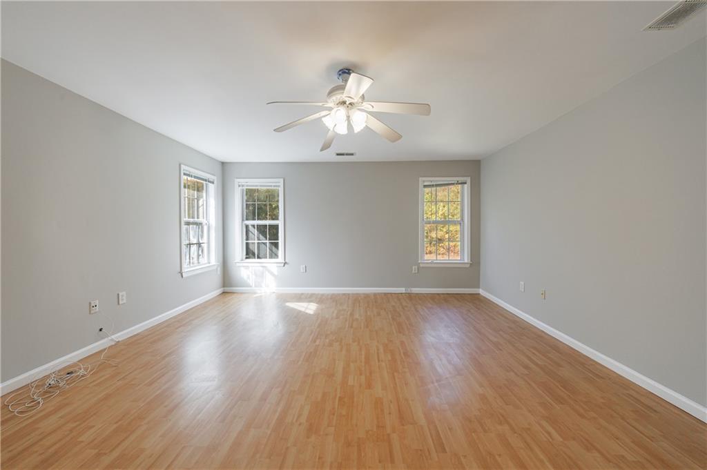 6790 Palace Lane Fairburn, GA 30213 - Photo 48 of 62 a view of an empty room with wooden floor and a window