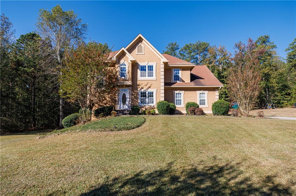 6790 Palace Lane Fairburn, GA 30213 - Photo 59 of 62 a front view of a house with a yard and garage