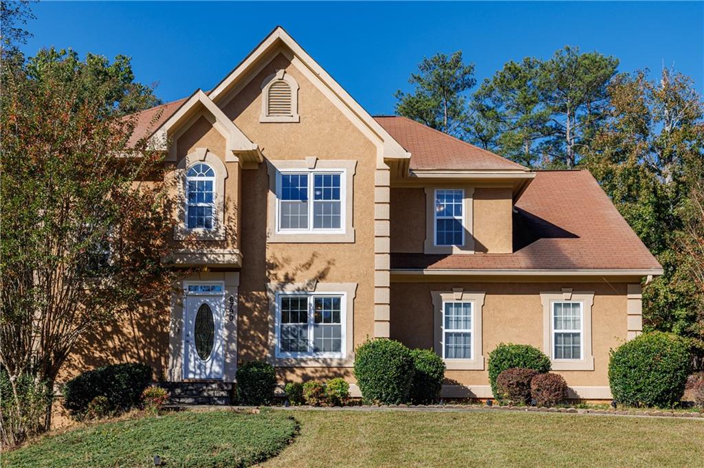 6790 Palace Lane Fairburn, GA 30213 - Photo 9 of 62 a front view of a house with a yard and trees